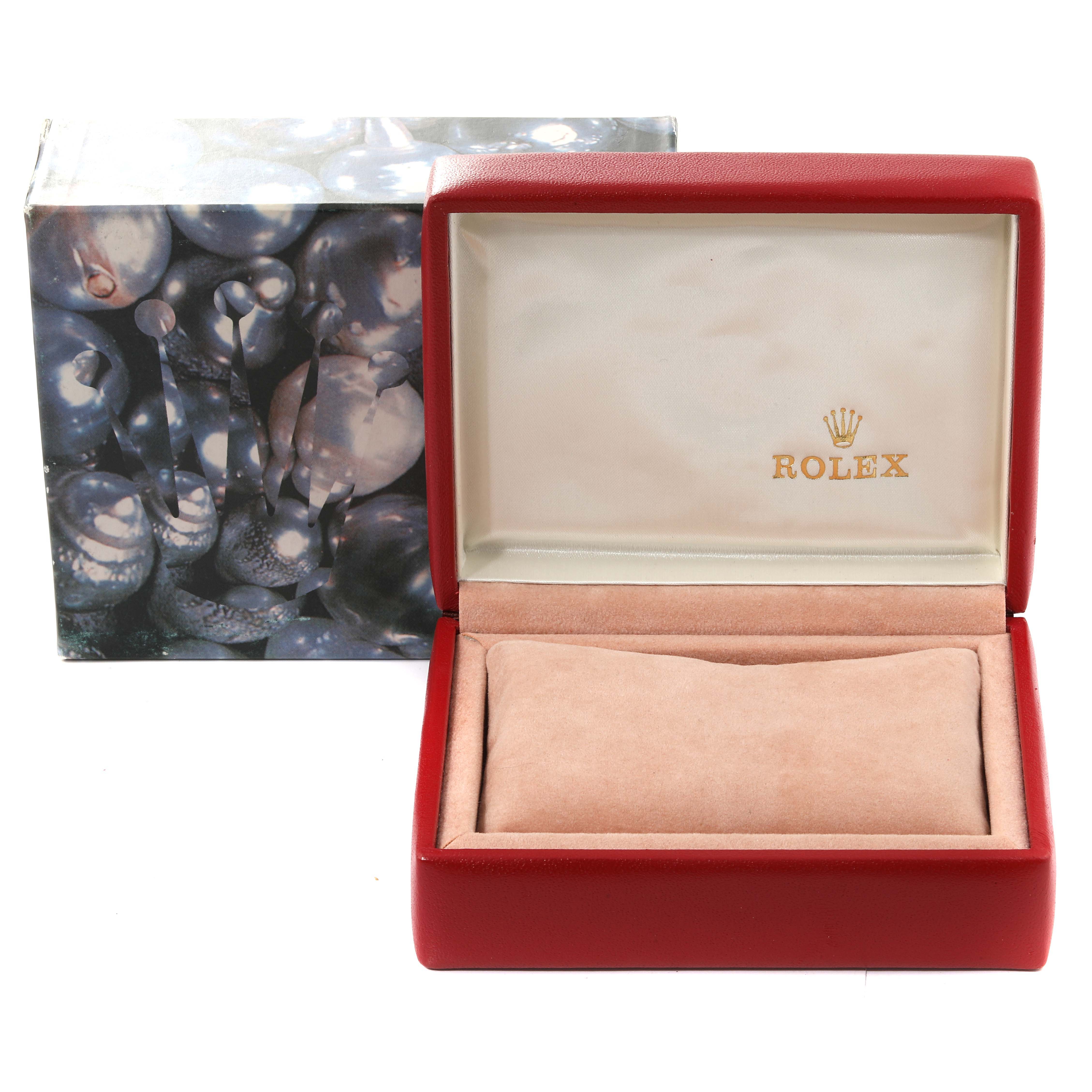 The image shows an open red Rolex Datejust 79174 Women's Stainless Steel White Dial 79174 Women's Stainless Steel White Dial watch box, revealing its beige interior along with its decorative outer box.