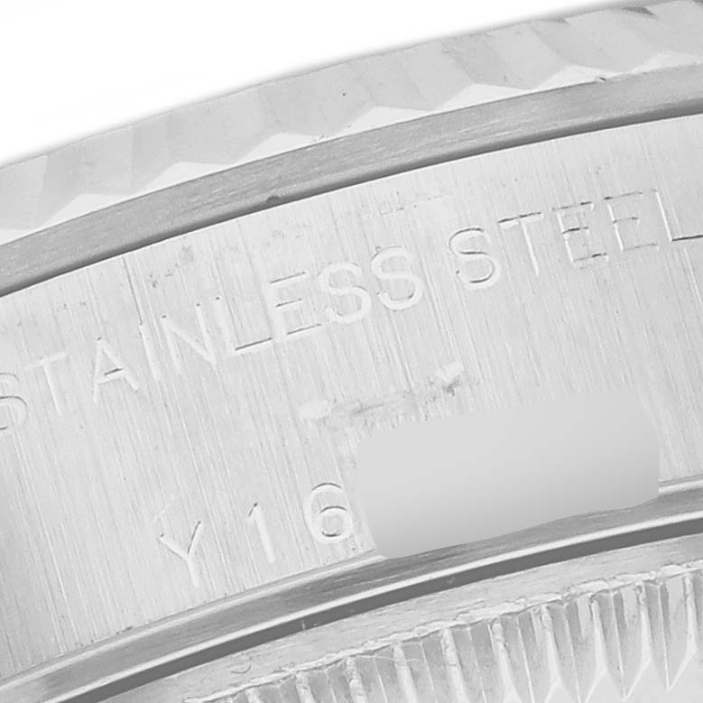 The image shows a close-up of the side of a Rolex Datejust 79174 Women's Stainless Steel White Dial 79174 Women's Stainless Steel White Dial watch case, focusing on the stainless steel engraving.