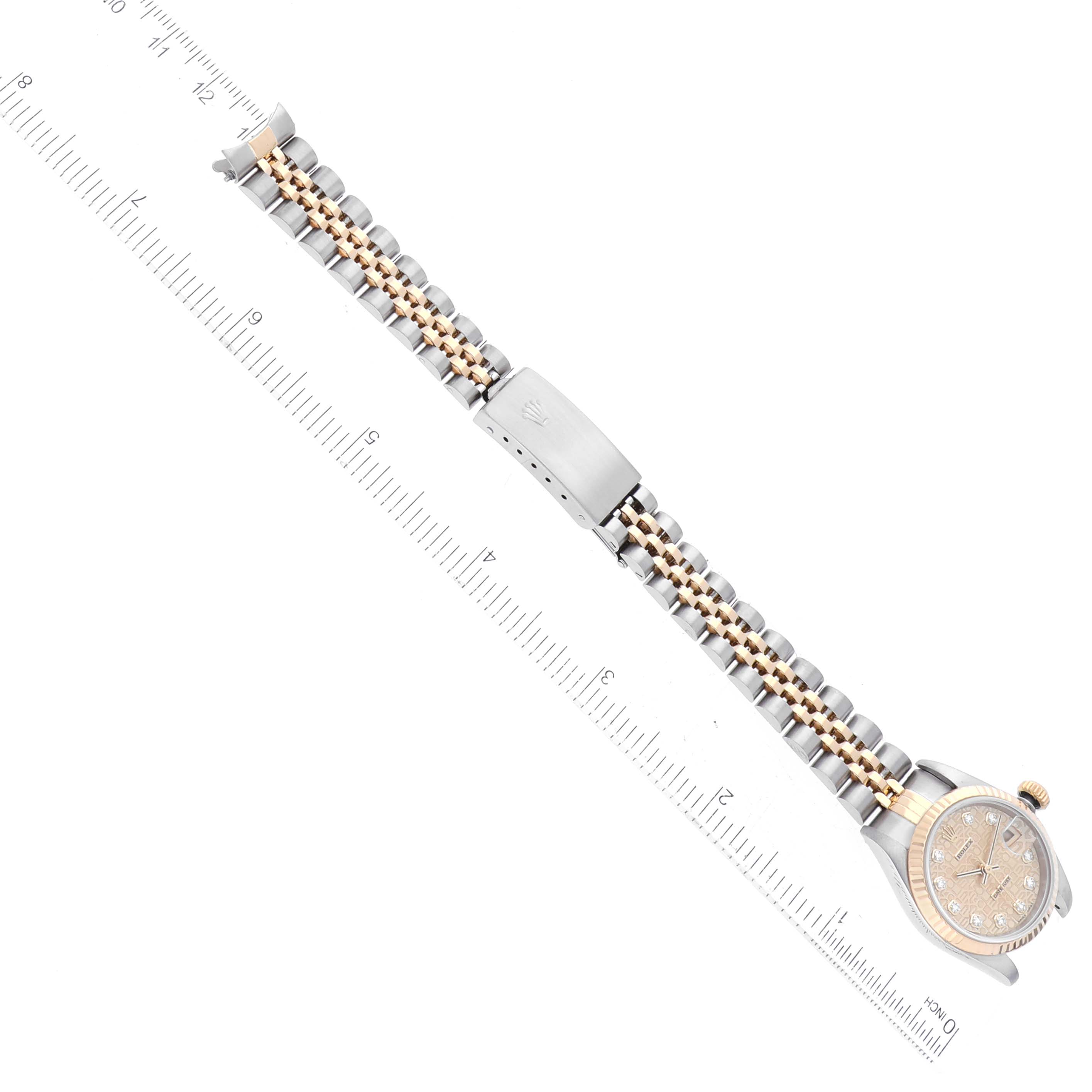 The image shows a top-down view of a Rolex Datejust 79173 Women's Steel and Gold (two tone) Champagne Dial 79173 Women's Steel and Gold (two tone) Champagne Dial watch, displaying the bracelet, clasp, and part of the dial next to a ruler.