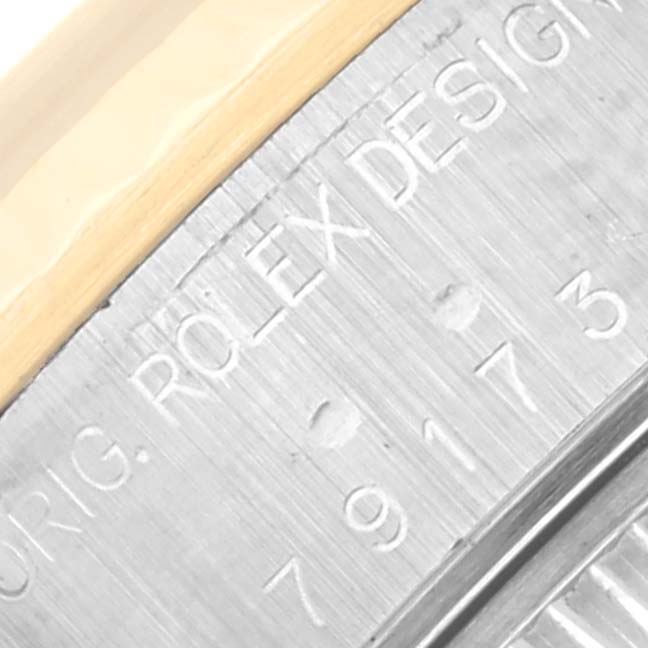 This image shows a close-up of the etched detailing on the side of the case of a Rolex Datejust 79173 Women's Steel and Gold (two tone) Champagne Dial 79173 Women's Steel and Gold (two tone) Champagne Dial watch.