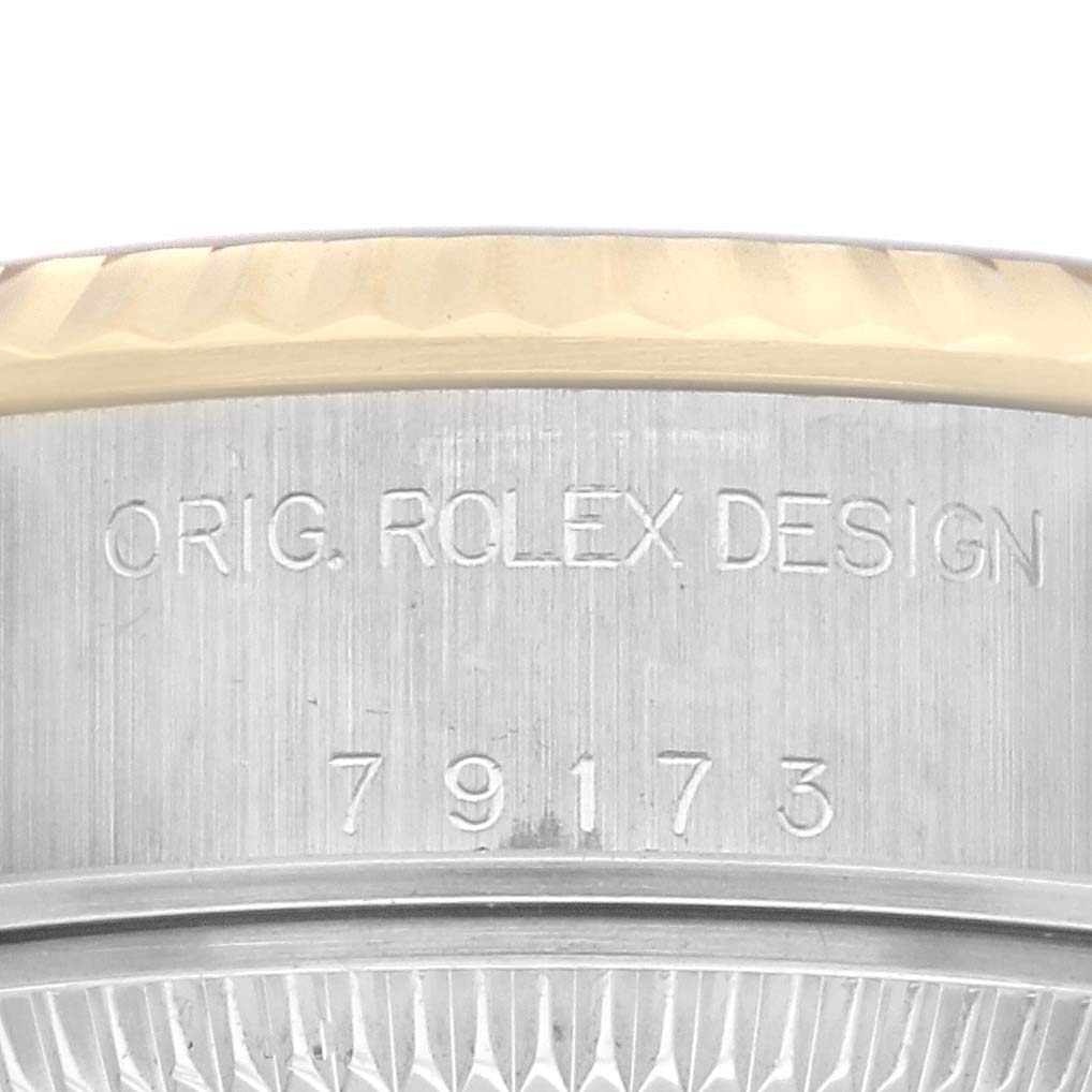 The image shows a detailed close-up of the side engraving and part of the bezel on a Rolex Datejust 79173 Women's Steel and Gold (two tone) Champagne Dial 79173 Women's Steel and Gold (two tone) Champagne Dial watch.