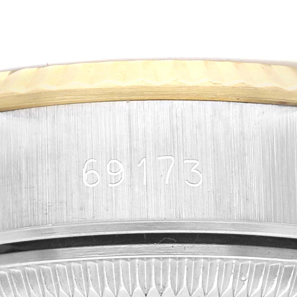 This image shows the side of a Rolex Datejust 69173 Women's Steel and Gold (two tone) Champagne Dial 69173 Women's Steel and Gold (two tone) Champagne Dial watch casing, highlighting the model number 69173 engraved on the stainless steel.