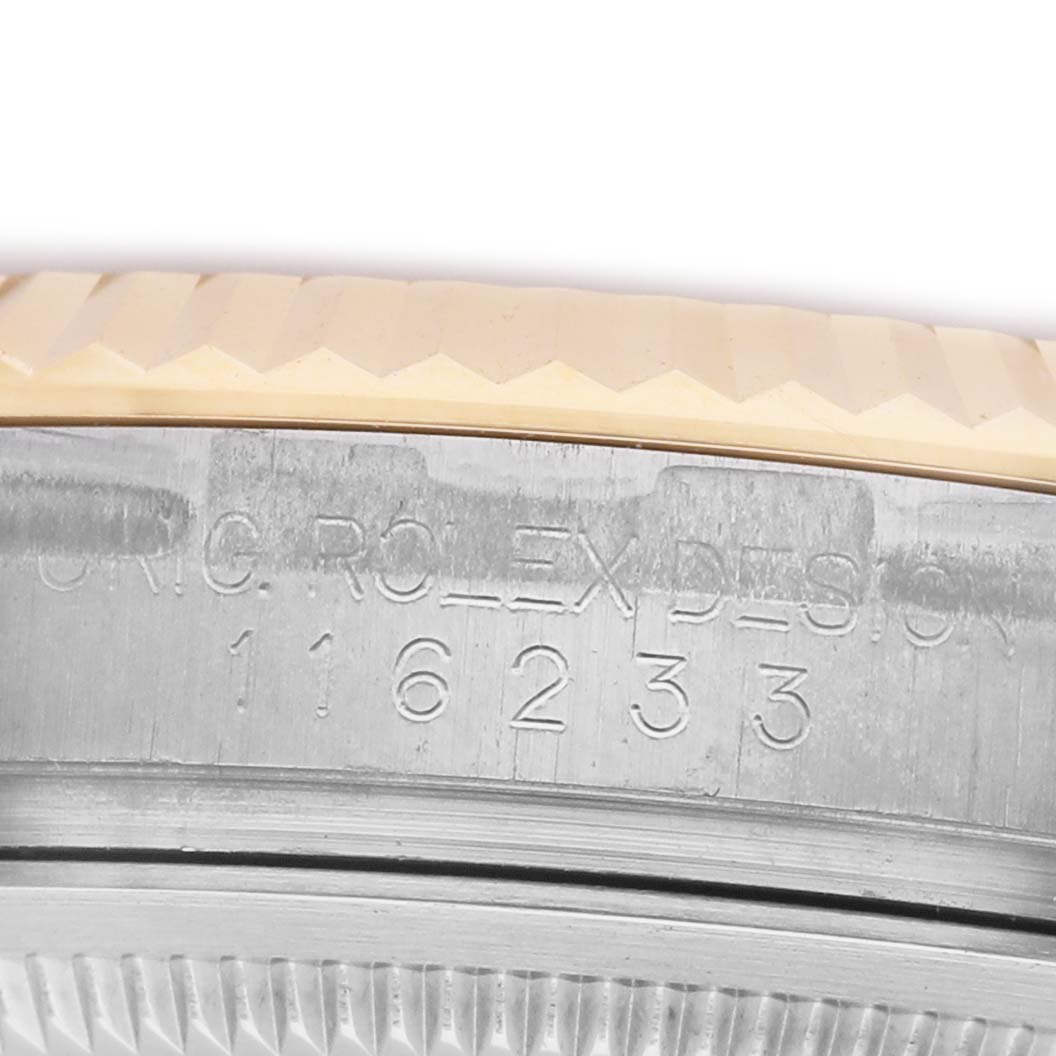 The image shows a close-up of the side of a Rolex Datejust 116233 Men's Stainless Steel Mother of Pearl Dial watch, focusing on the engraved serial number on the case.