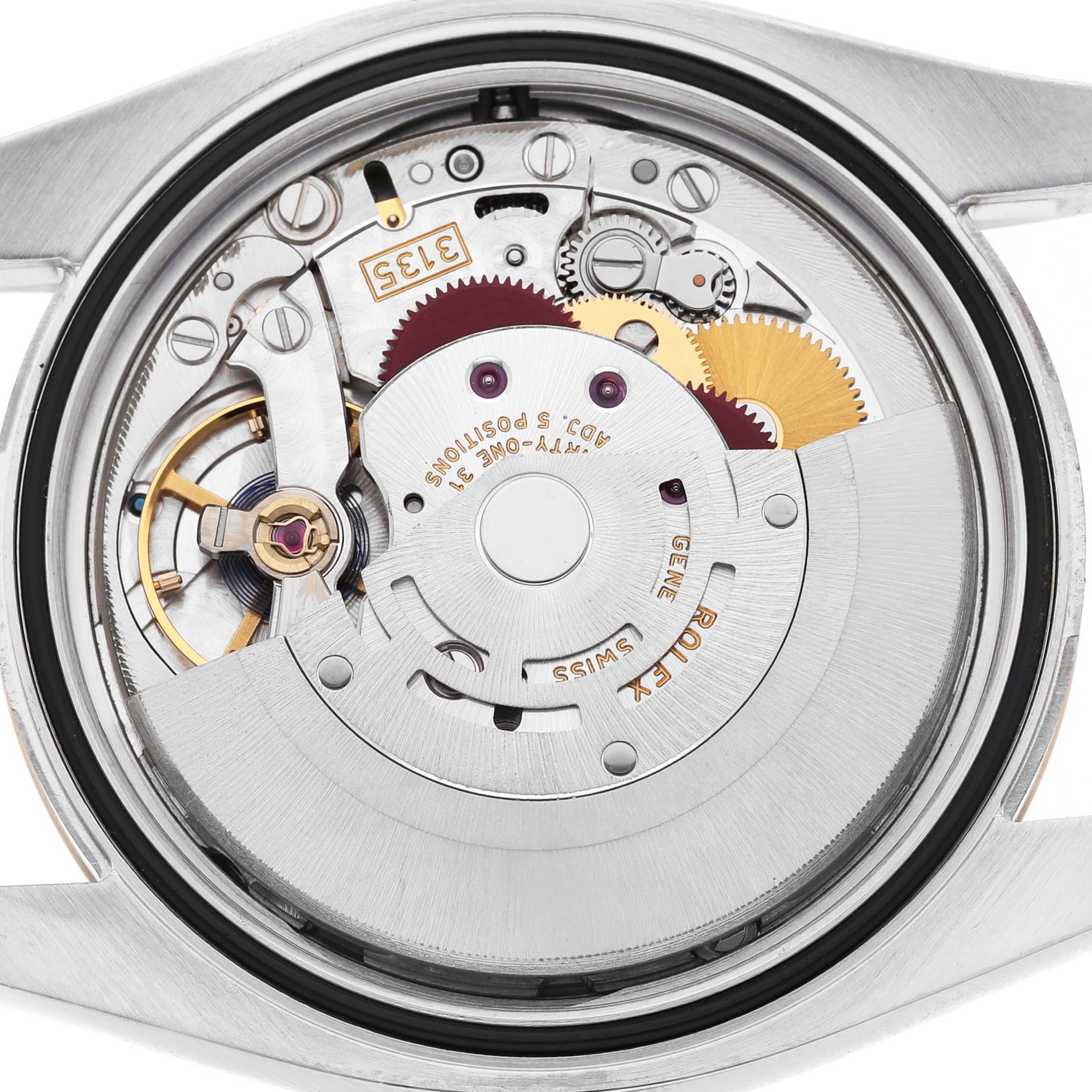 The image shows the movement of a Rolex Datejust 116233 Men's Stainless Steel Mother of Pearl Dial watch from a top-down view, revealing gears and mechanical components.