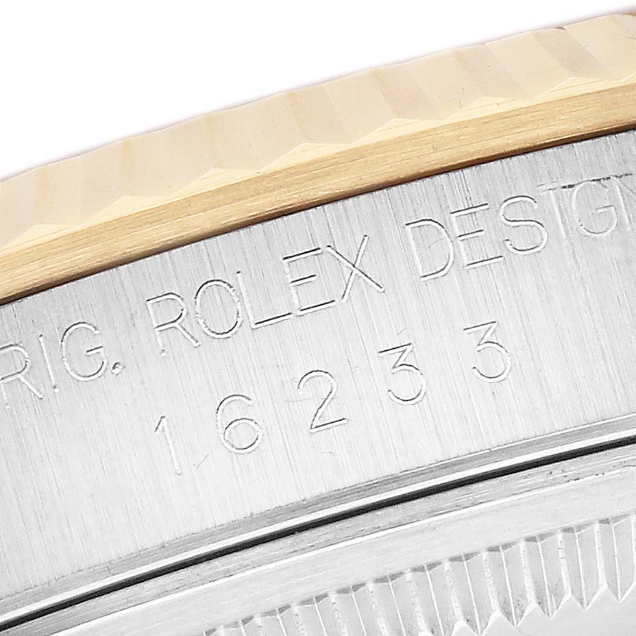 This close-up image shows the engraved side of a Rolex Datejust 16233 Men's Steel and Gold (two tone) White Dial 16233 Men's Steel and Gold (two tone) White Dial model, highlighting the model number and part of the bezel.