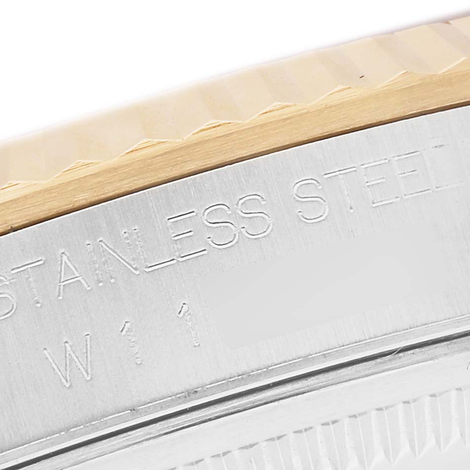 This image shows a close-up of the bezel and case side of a Rolex Datejust 16233 Men's Steel and Gold (two tone) White Dial 16233 Men's Steel and Gold (two tone) White Dial watch, highlighting the stainless steel and gold details.