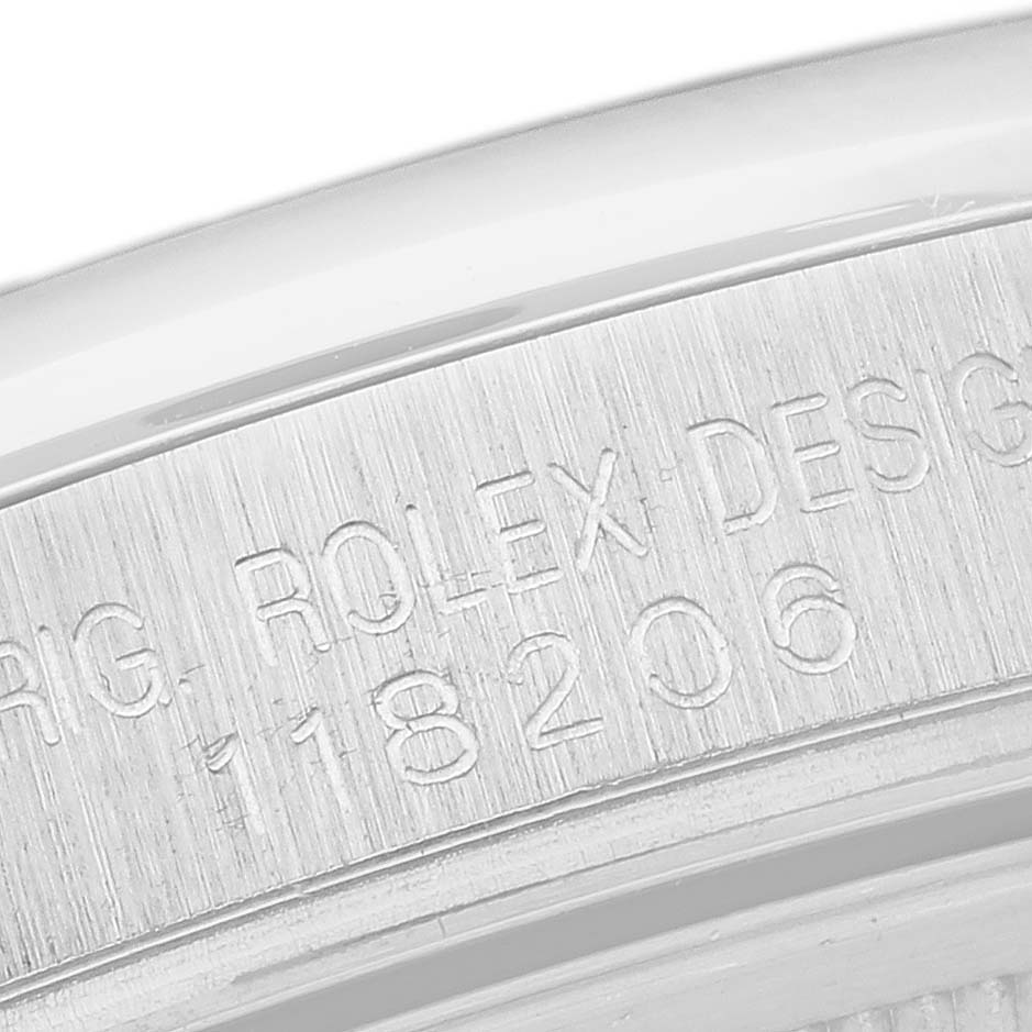 The close-up image shows the engraved case back edge of a Rolex President 118206 Men's Platinum Silver Dial 118206 Men's Platinum Silver Dial model watch, detailing the brand and model number.