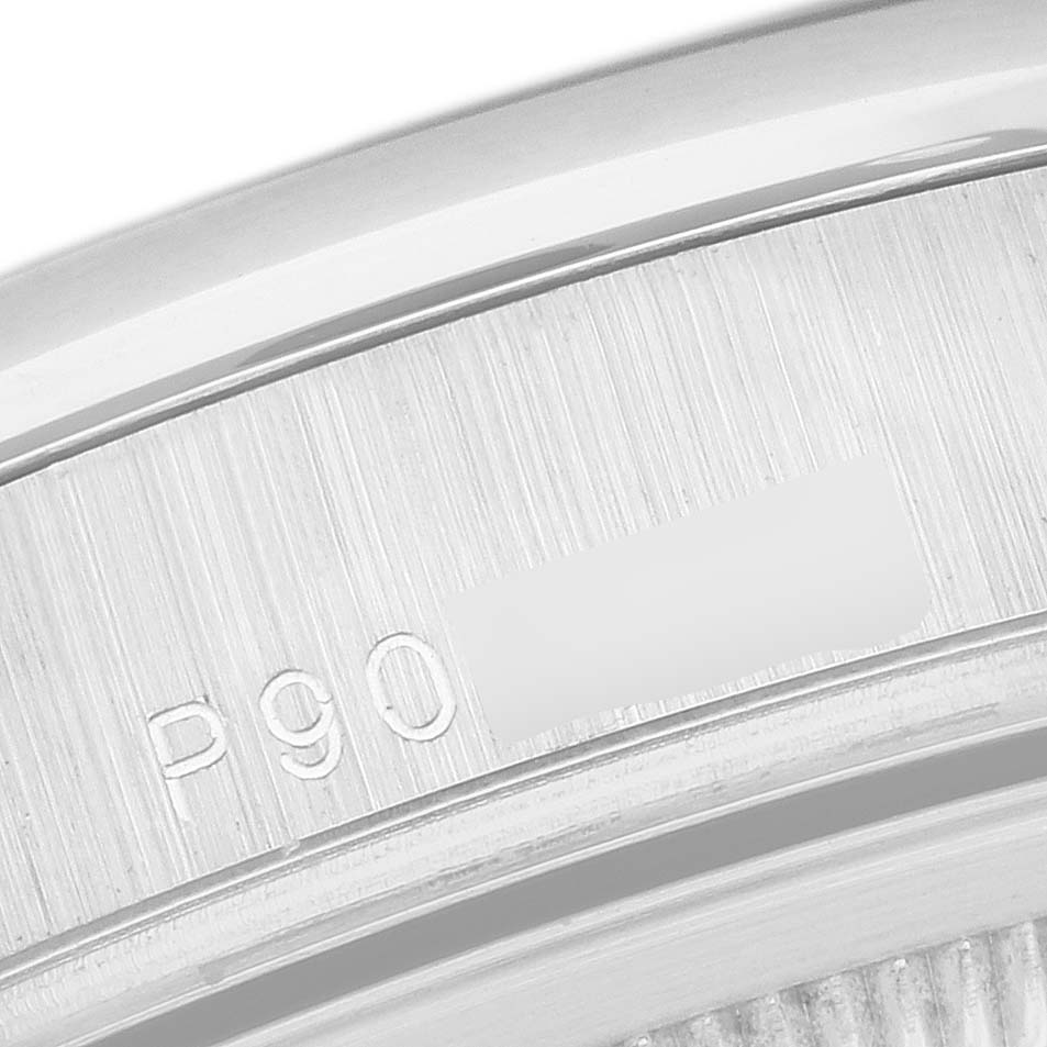 The image shows a close-up of the edge, likely the case back, of a Rolex President 118206 Men's Platinum Silver Dial 118206 Men's Platinum Silver Dial model watch with partial engraving visible.