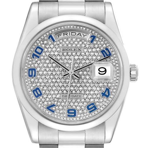 The image shows a close-up view of the Rolex President model watch, highlighting its diamond-encrusted dial and blue numerals.