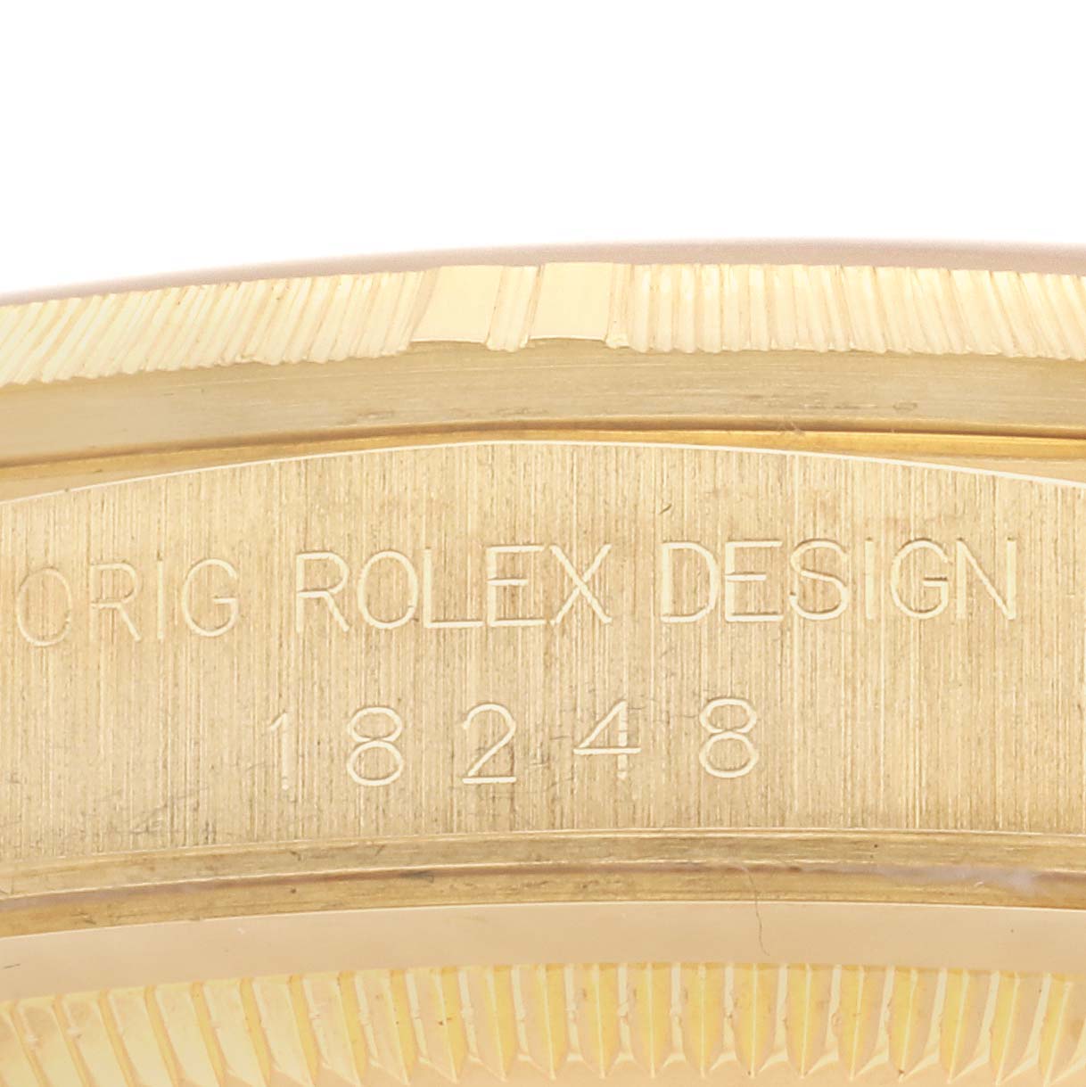This image shows a close-up of the engraved inner bezel and serial number on a Rolex President 18248 Men's Yellow Gold Champagne Dial 18248 Men's Yellow Gold Champagne Dial model watch.