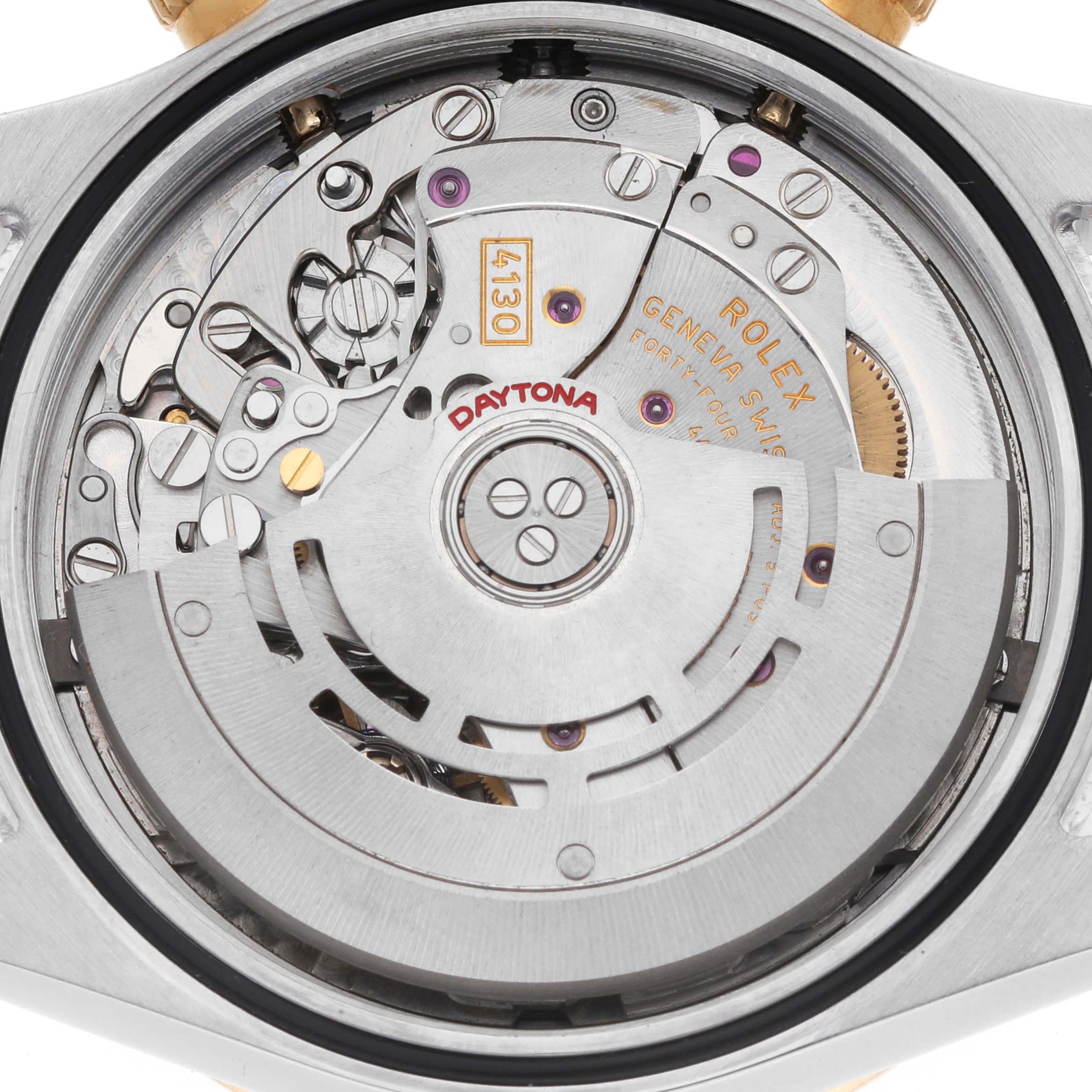 The image shows a close-up of the movement inside a Rolex Daytona 116523 Men
s Steel and Gold (two tone) Black Dial watch, highlighting its intricate mechanical parts.