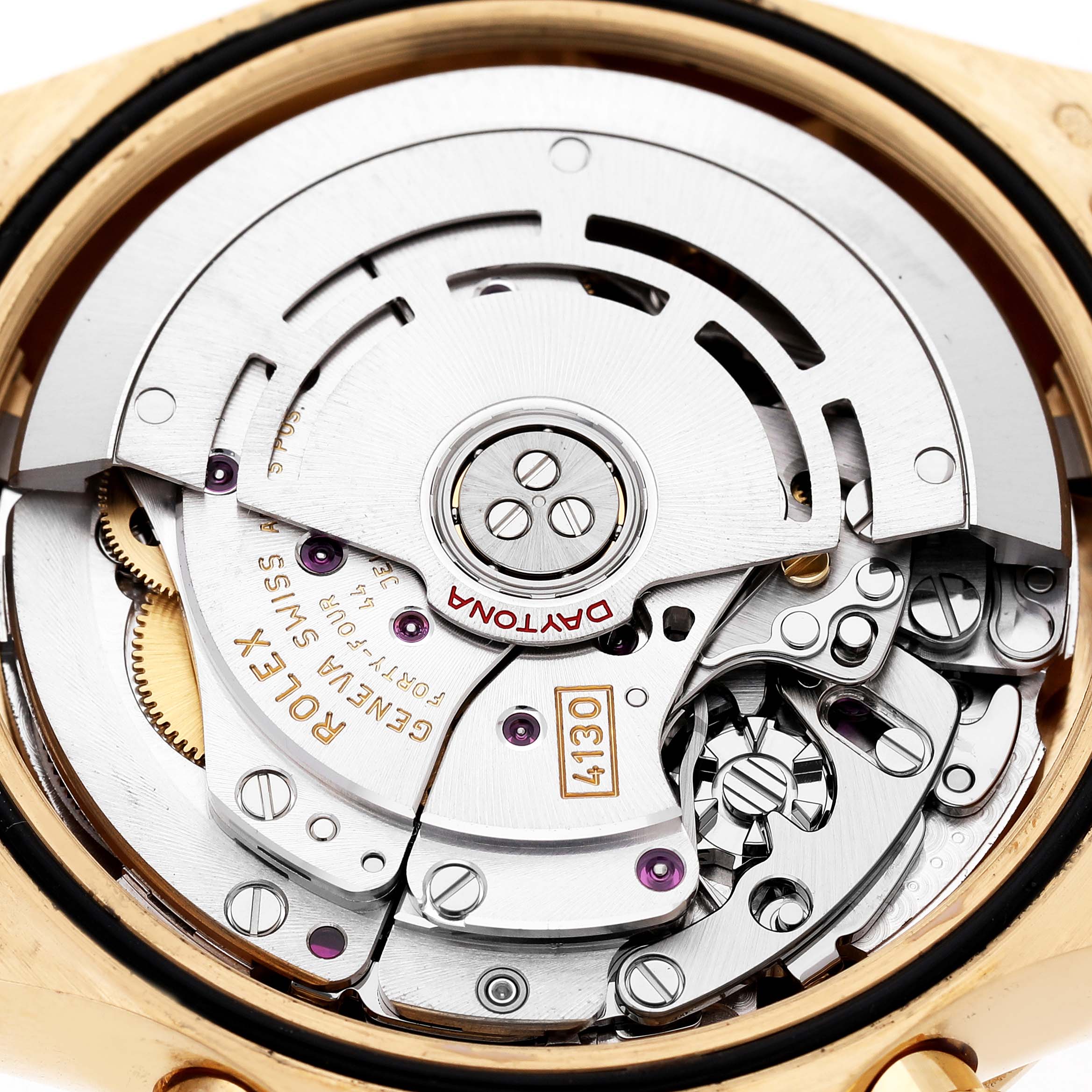 The image shows the movement of a Rolex Daytona 116508 Men's Yellow Gold Green Dial, featuring gears and engravings, viewed from the back.