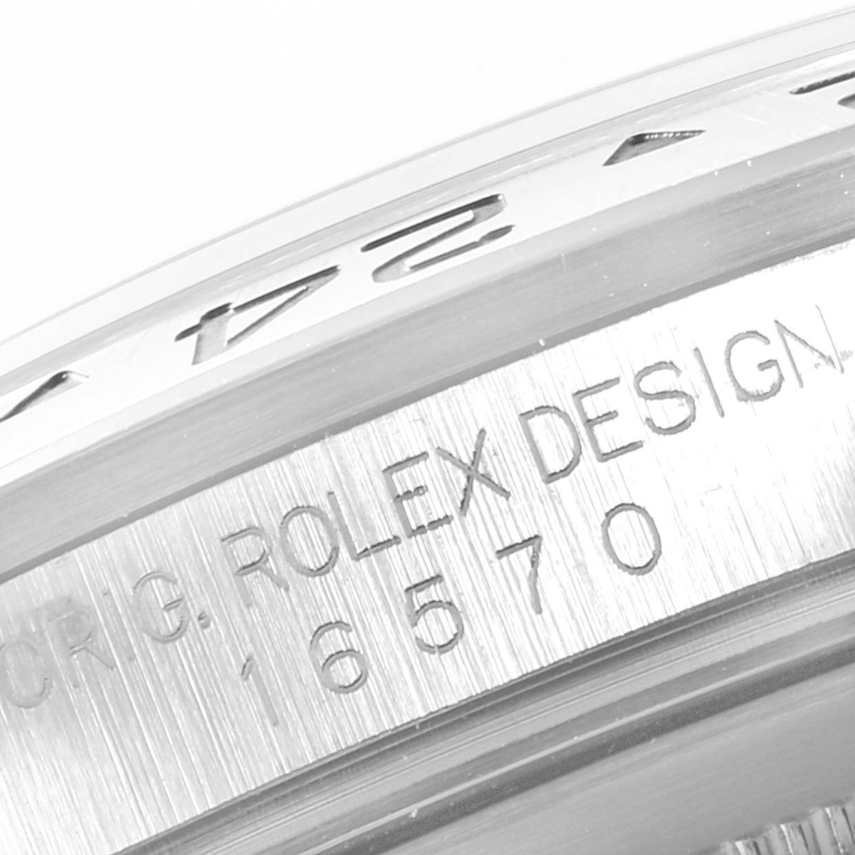 The image shows a close-up of the engraved bezel and case side of a Rolex Explorer 16570 Men
s Stainless Steel Black Dial 16570 Men
s Stainless Steel Black Dial model.
