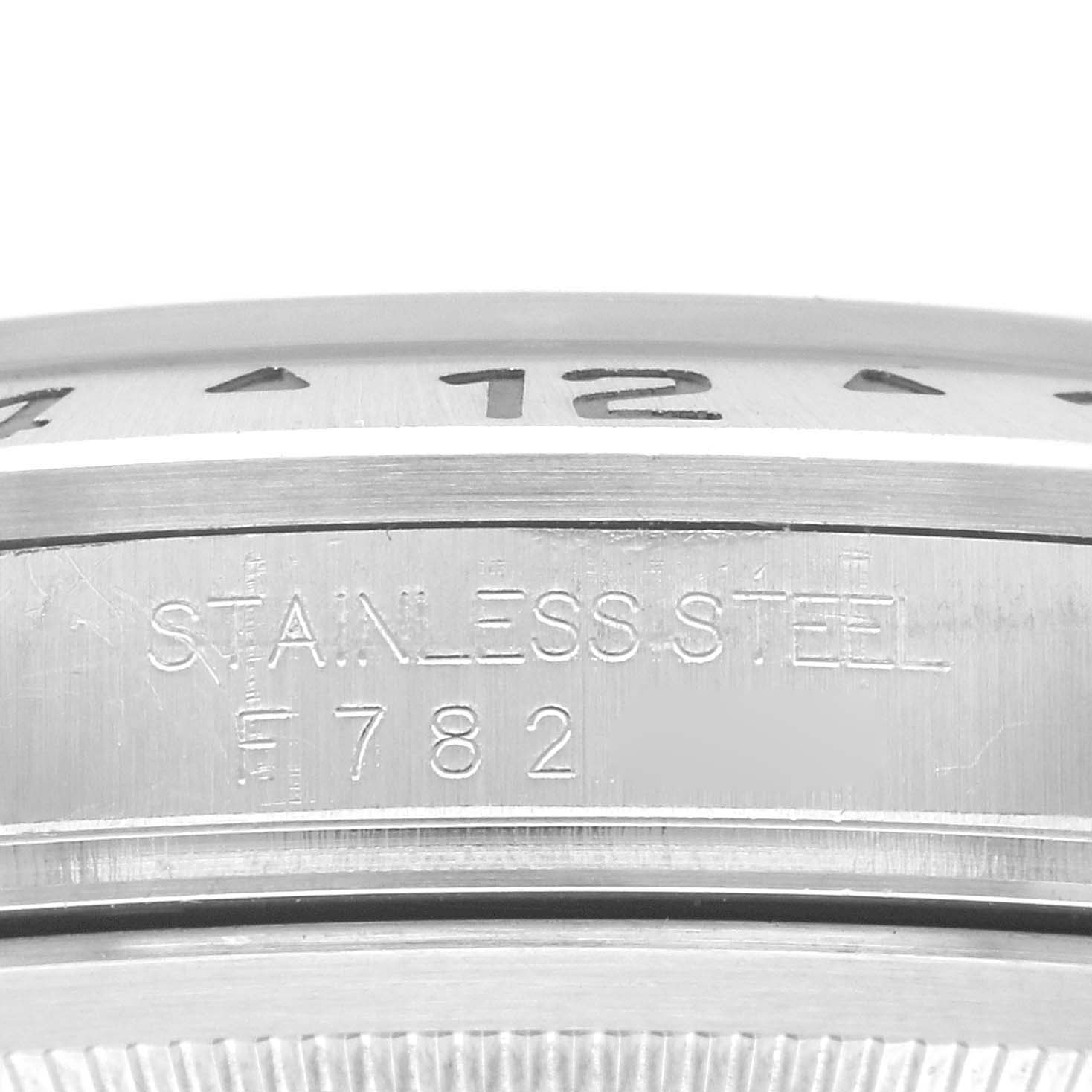 This image shows the side profile of a Rolex Explorer 16570 Men's Stainless Steel Black Dial 16570 Men's Stainless Steel Black Dial's stainless steel case, featuring part of the engraved model number and markings.