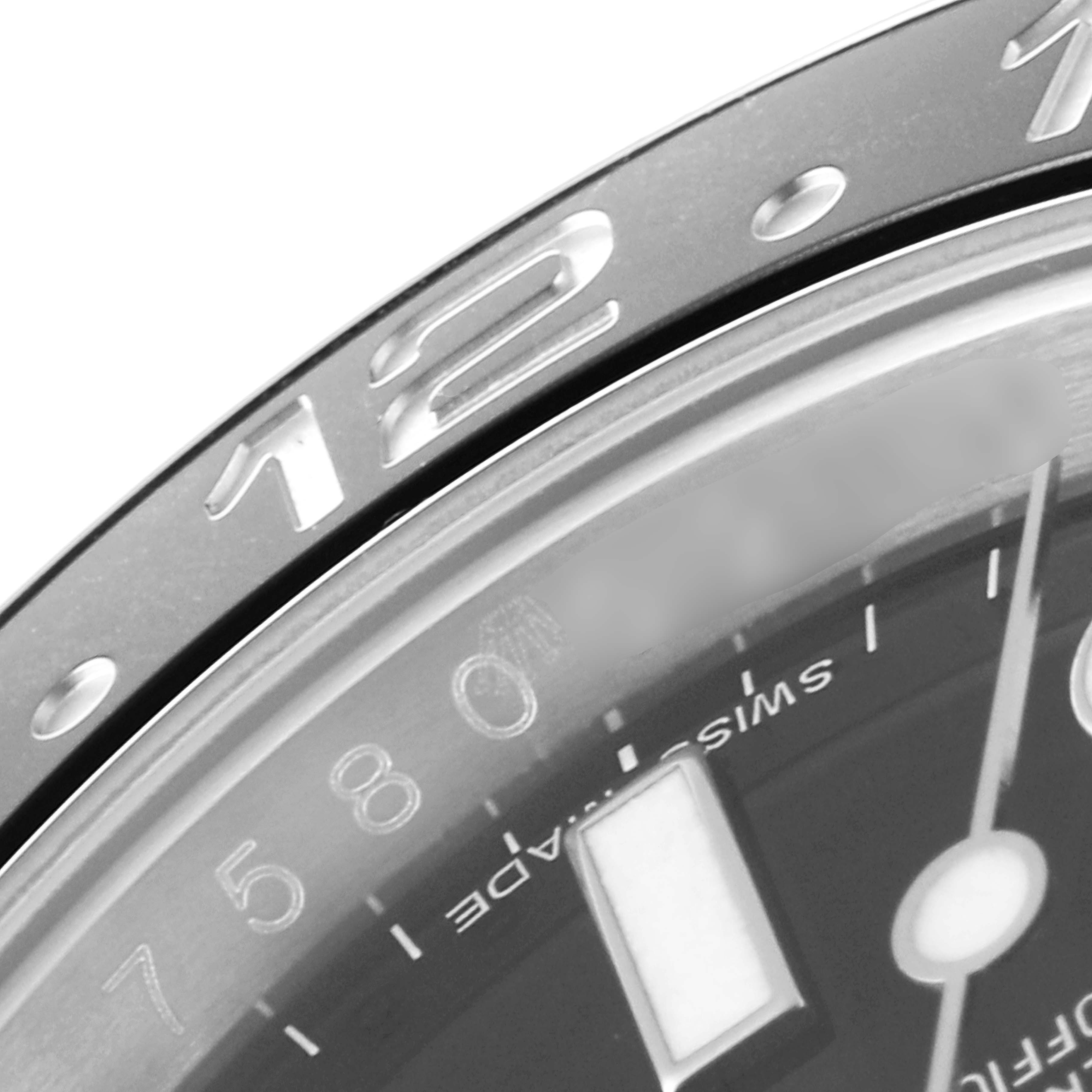 The image shows a close-up of the bezel and partial dial of a Rolex GMT-Master 116710 Men's Stainless Steel Black Dial 116710 Men's Stainless Steel Black Dial watch.