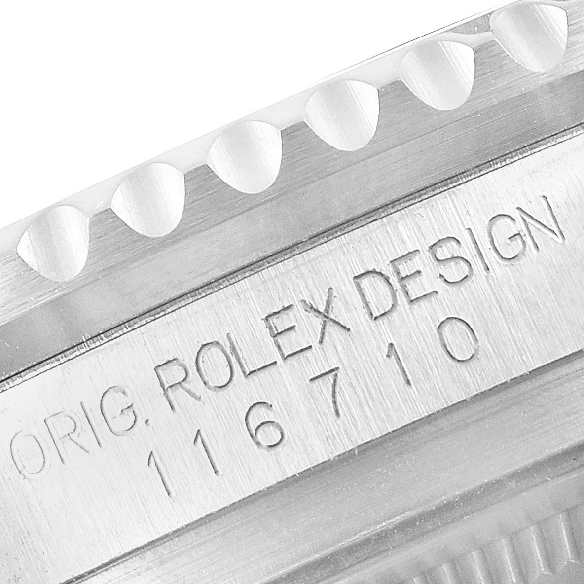 This close-up image of the Rolex GMT-Master 116710 Men's Stainless Steel Black Dial 116710 Men's Stainless Steel Black Dial watch shows the engraving and part of the bezel.