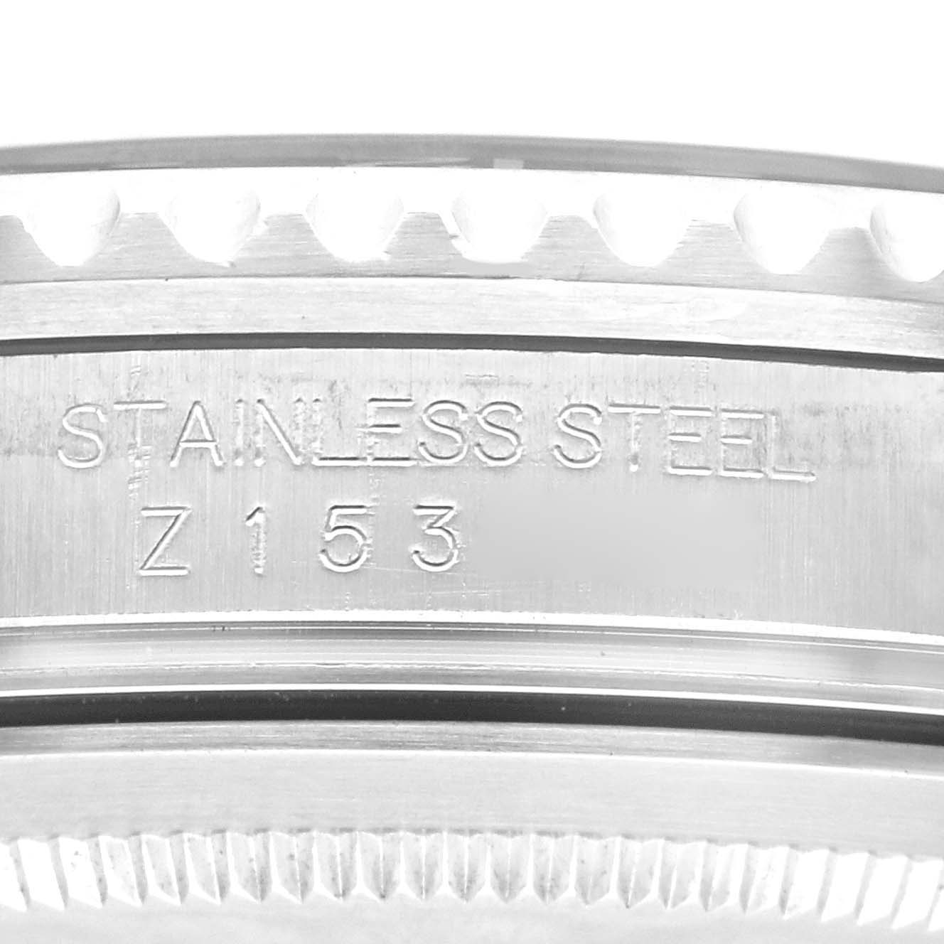 The image shows a close-up of the case side of a Rolex GMT-Master 16710 Men's Stainless Steel Black Dial 16710 Men's Stainless Steel Black Dial watch, displaying its "STAINLESS STEEL" engraving and serial number.