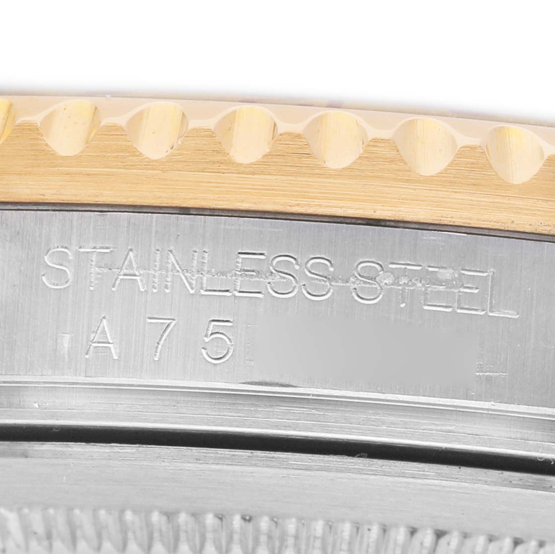 The image shows a close-up of the stainless steel case and bezel edge of a Rolex GMT-Master 16713 Men's Steel and Gold (two tone) Brown Dial watch.