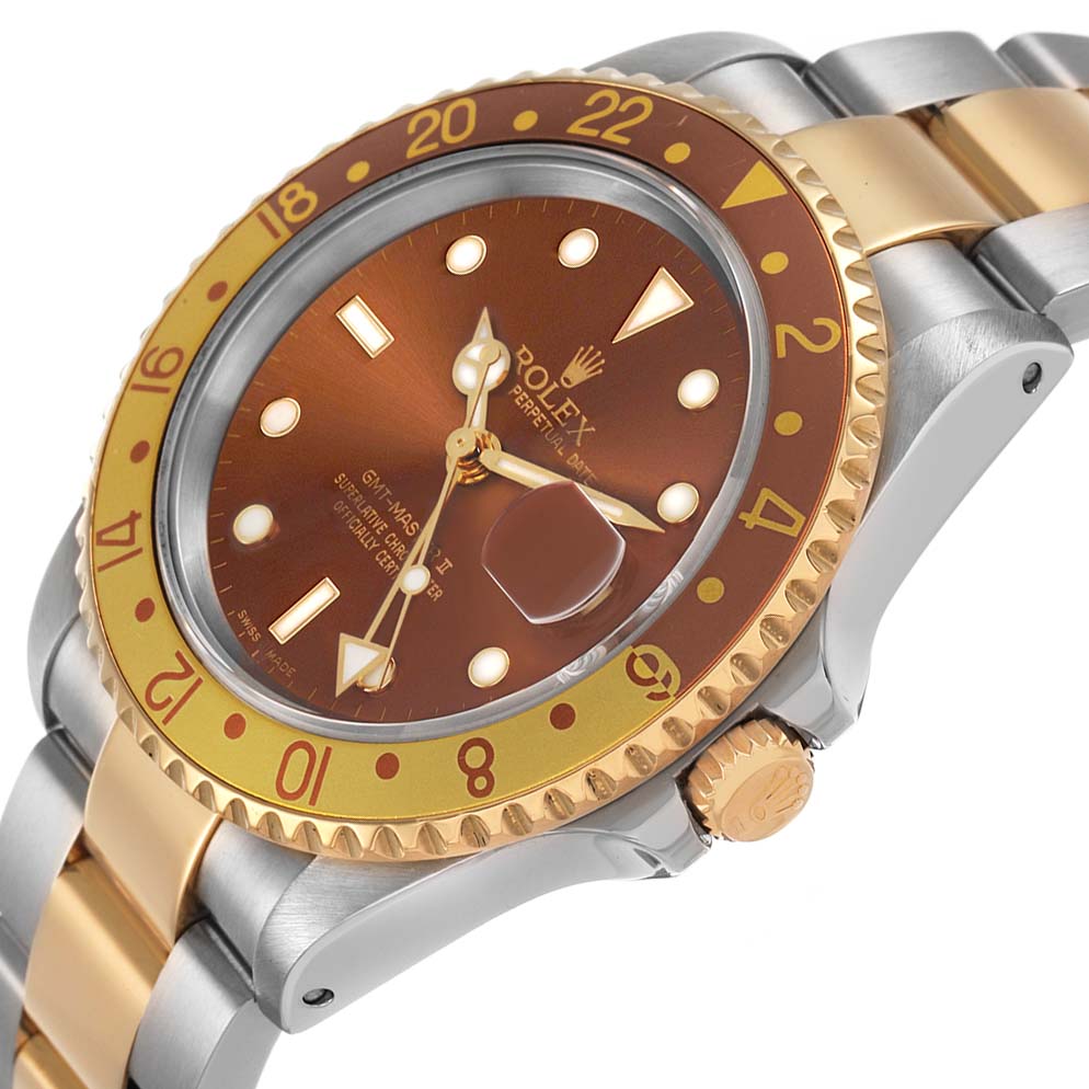 The Rolex GMT-Master 16713 Men's Steel and Gold (two tone) Brown Dial watch is shown at a three-quarter angle, highlighting the bezel, dial, crown, and part of the bracelet.