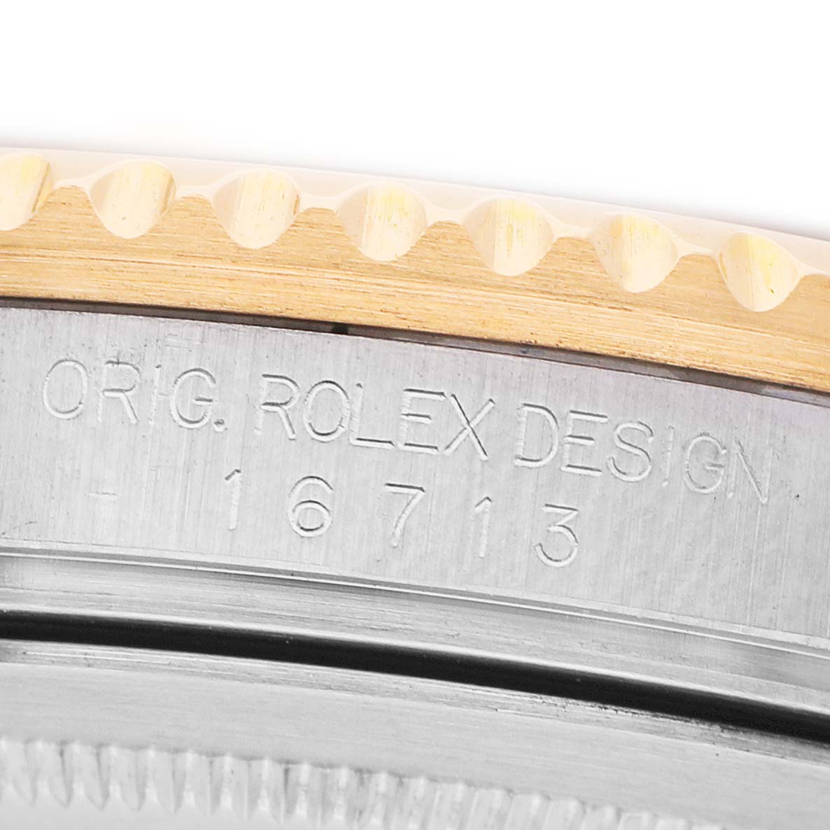 The image shows a close-up of the Rolex GMT-Master 16713 Men's Steel and Gold (two tone) Brown Dial model's side, highlighting the bezel edge and engraved model number.
