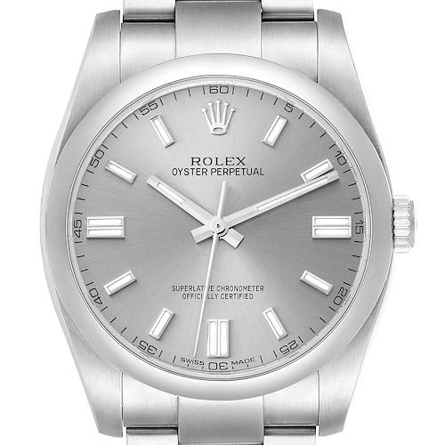 The image shows a front view of a Rolex Oyster Perpetual, highlighting the dial, hands, markers, and part of the bracelet.