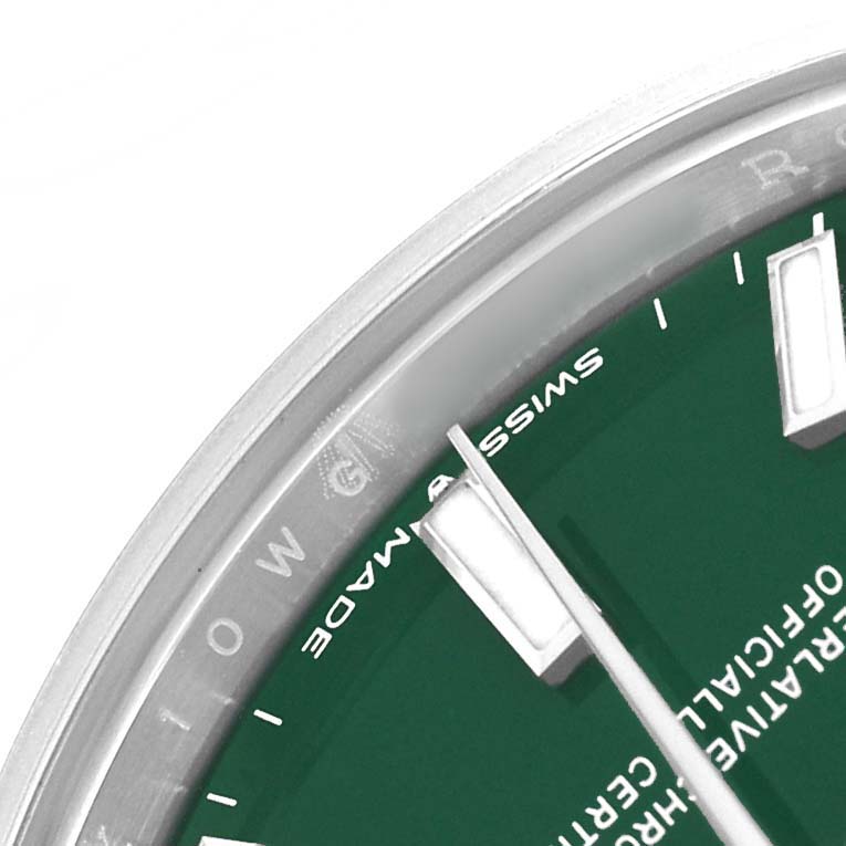 The image shows a close-up of the Rolex Mid-Size 277200 Women's Stainless Steel Green Dial watch face, focusing on the bezel, dial, and hour markers from an angled side view.