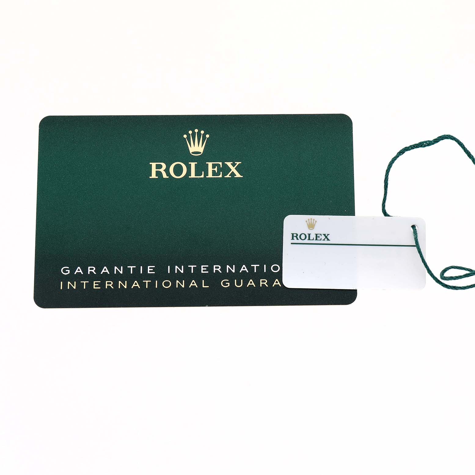 The image shows a Rolex international guarantee card and a tag, associated with the Mid-Size model.