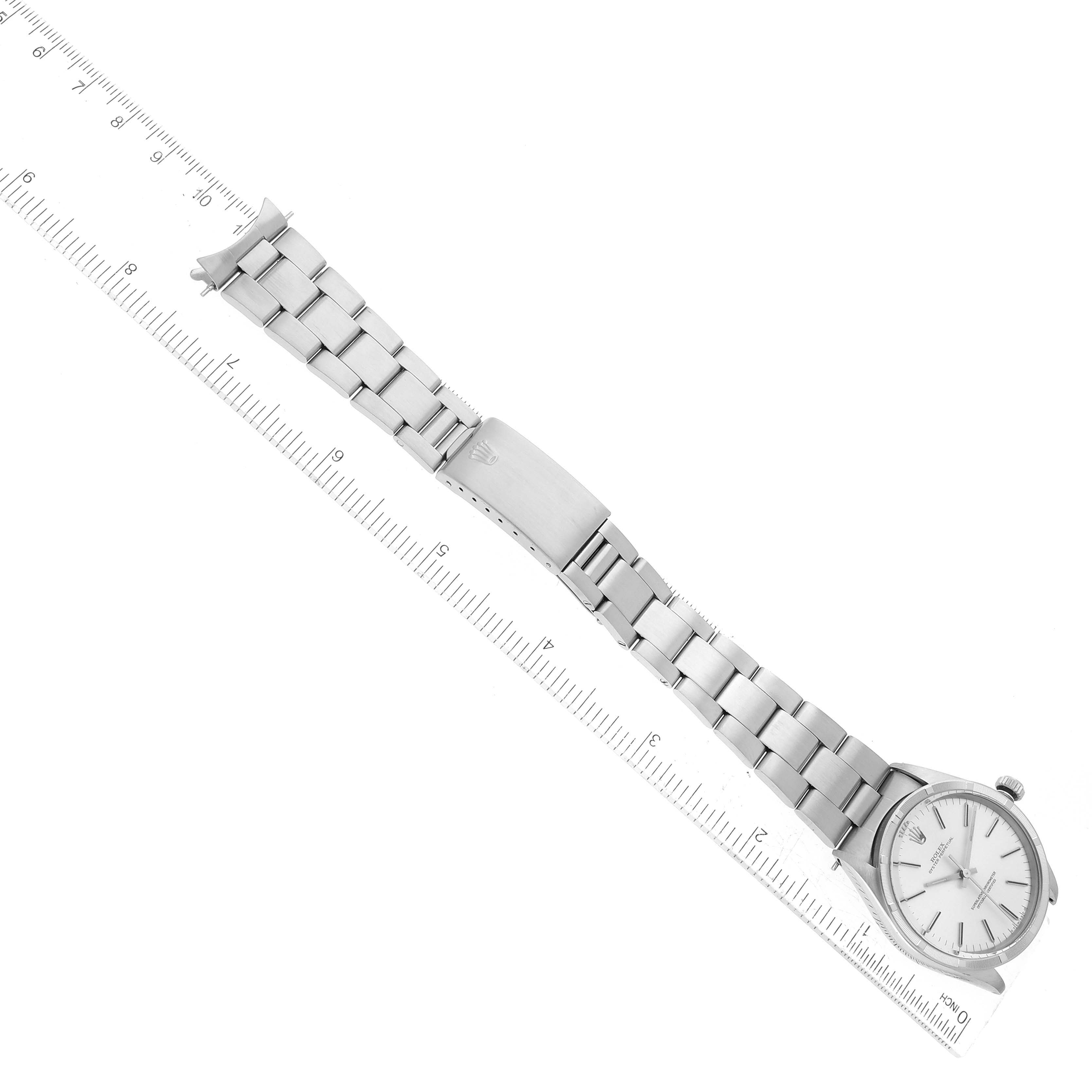 The Rolex Vintage Collection 1007 Men's Stainless Steel Silver Dial 1007 Men's Stainless Steel Silver Dial watch is shown laid out flat with its full bracelet and clasp visible, alongside a ruler for scale.