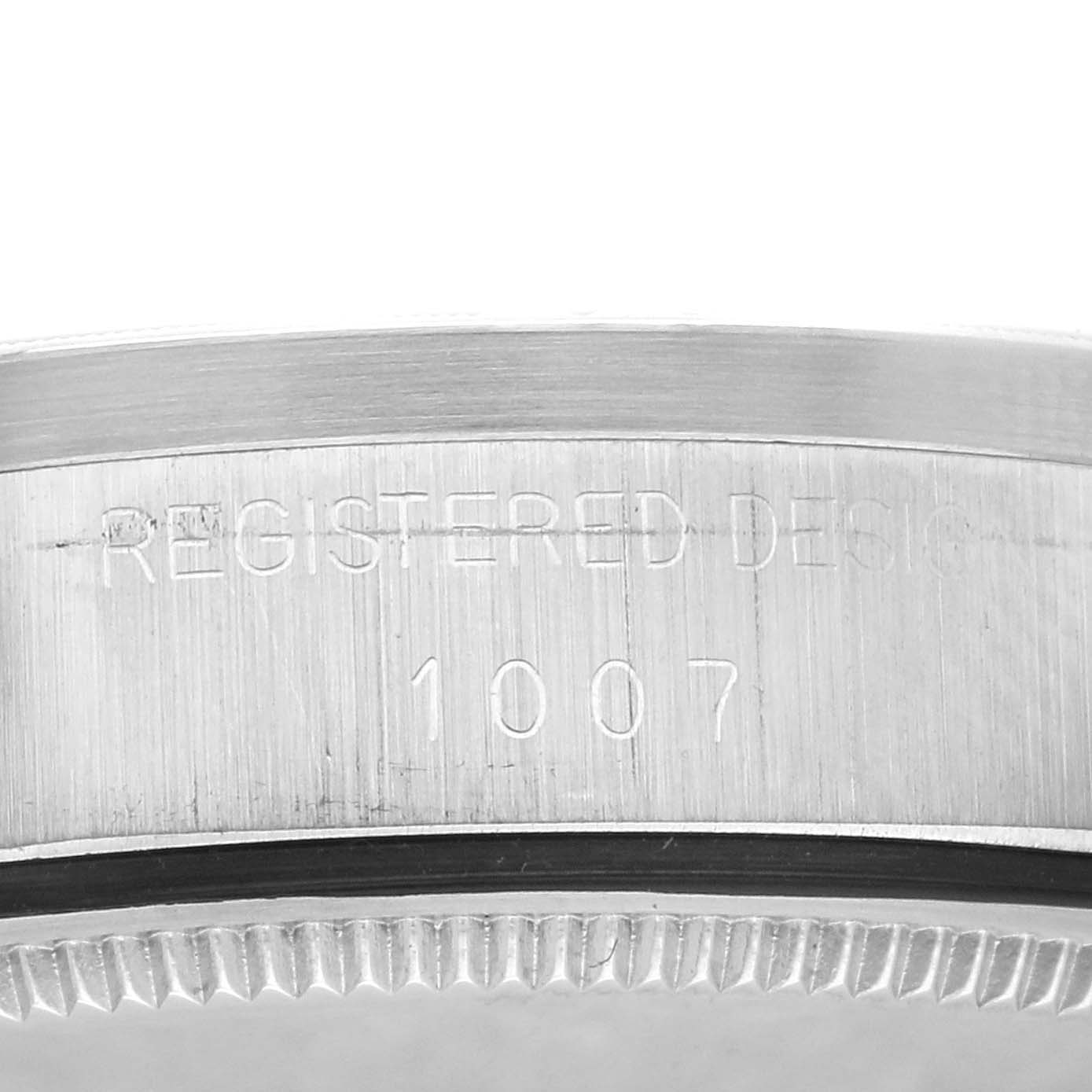 The image shows a close-up of the side engraving on the bezel of a Rolex Vintage Collection 1007 Men's Stainless Steel Silver Dial 1007 Men's Stainless Steel Silver Dial model watch.