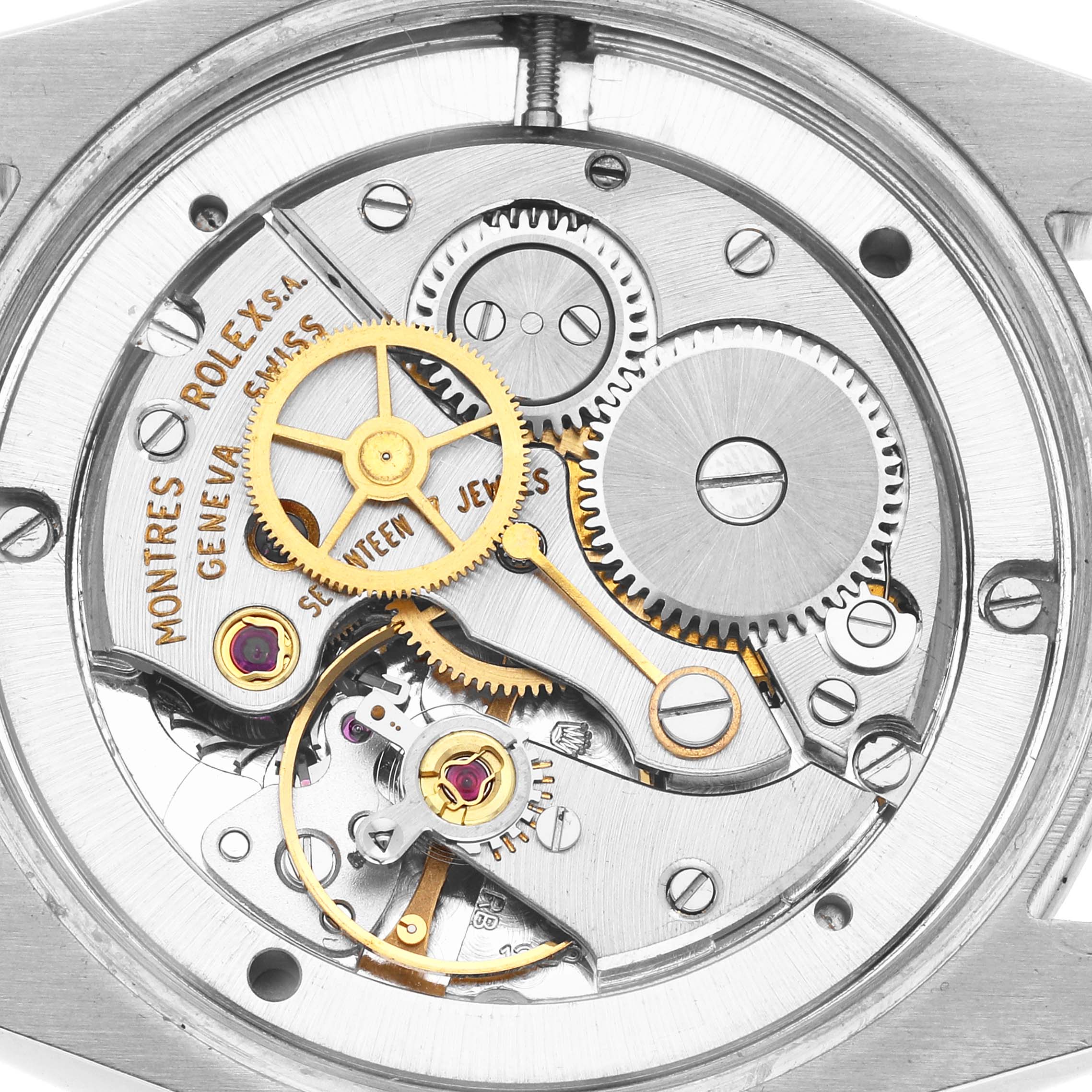 The image shows the inner mechanical movement of a Rolex Vintage Collection 6694 Men
s Stainless Steel White Dial watch from a top-down angle, highlighting the gears and components.