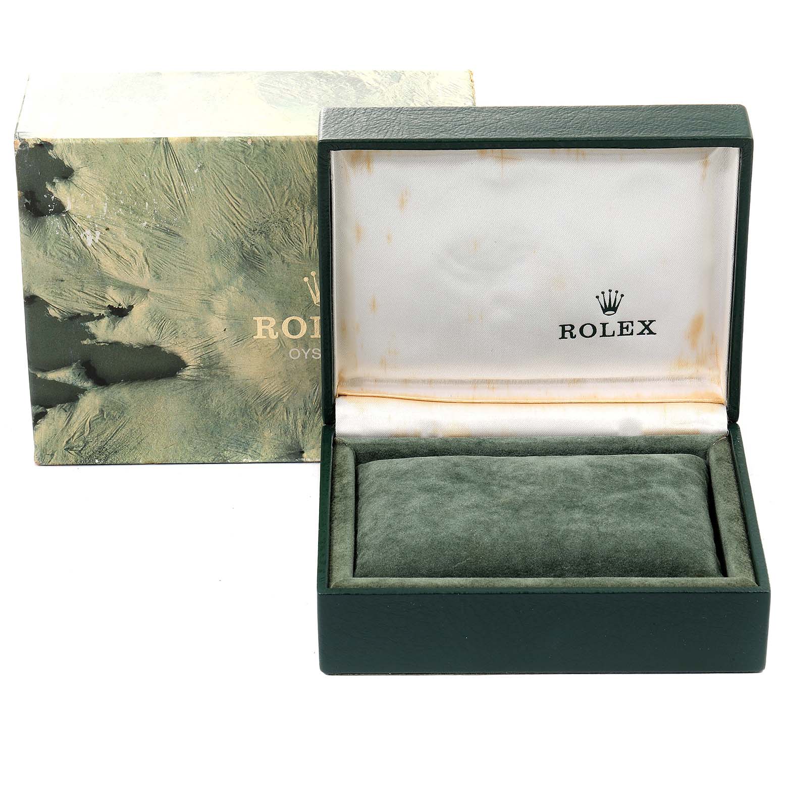 This image shows an empty green Rolex box for an Oysterquartz model, with another decorative box behind it.