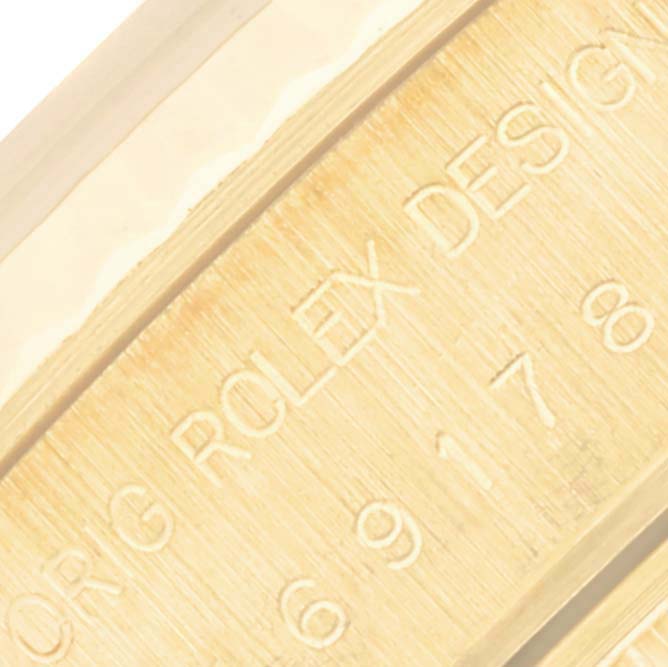 This close-up image shows a portion of the engraved caseback of a Rolex President 69178 Women's Yellow Gold Silver Dial 69178 Women's Yellow Gold Silver Dial model watch.