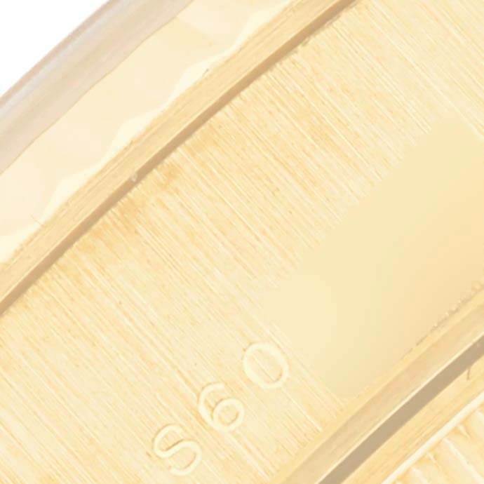 The image shows a close-up of the side of a gold Rolex President 69178 Women's Yellow Gold Silver Dial 69178 Women's Yellow Gold Silver Dial model watch band.