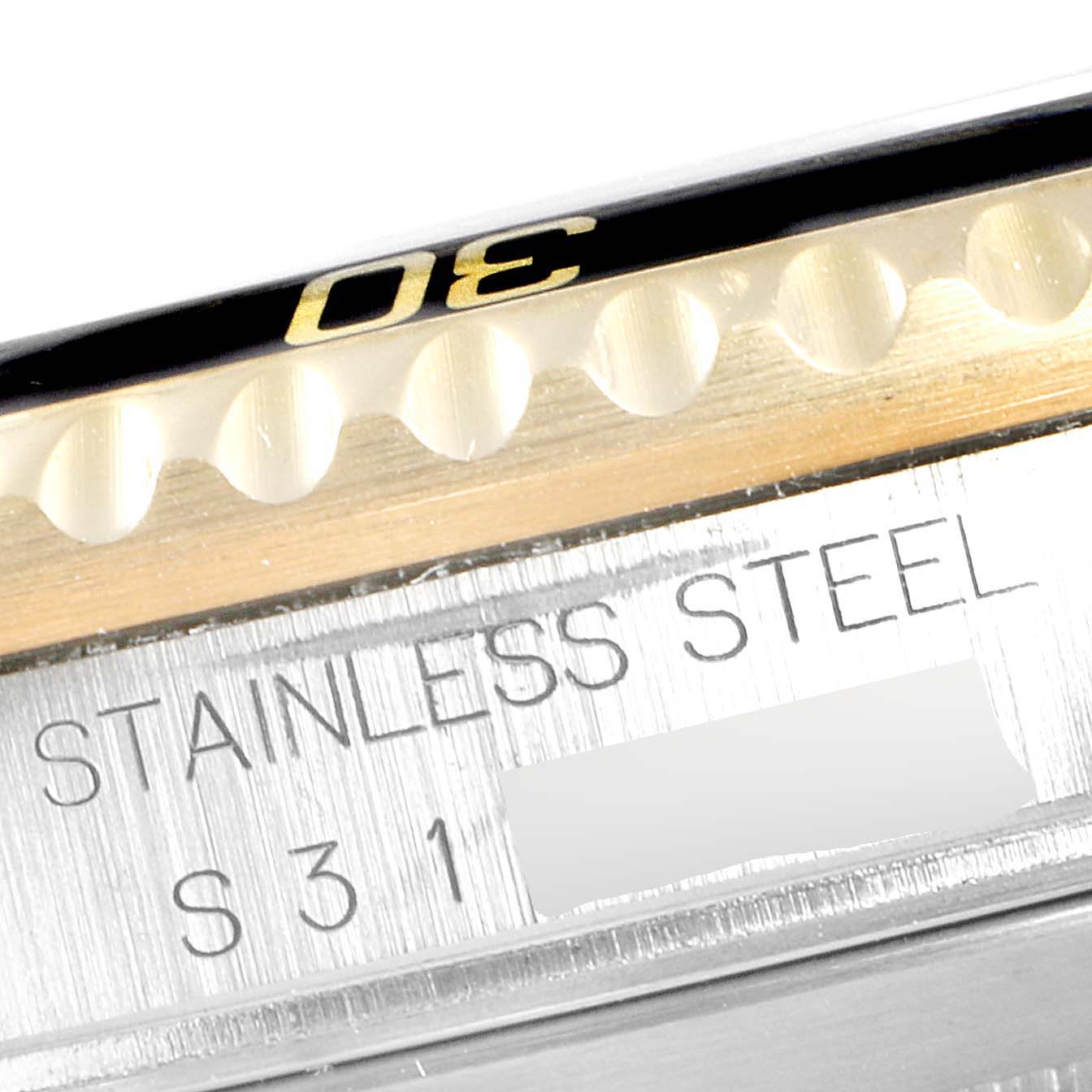 This close-up image shows a partial view of the bezel and the engraving on the case of a Rolex Submariner 16613 Men
s Steel and Gold (two tone) Black Dial 16613 Men
s Steel and Gold (two tone) Black Dial watch.