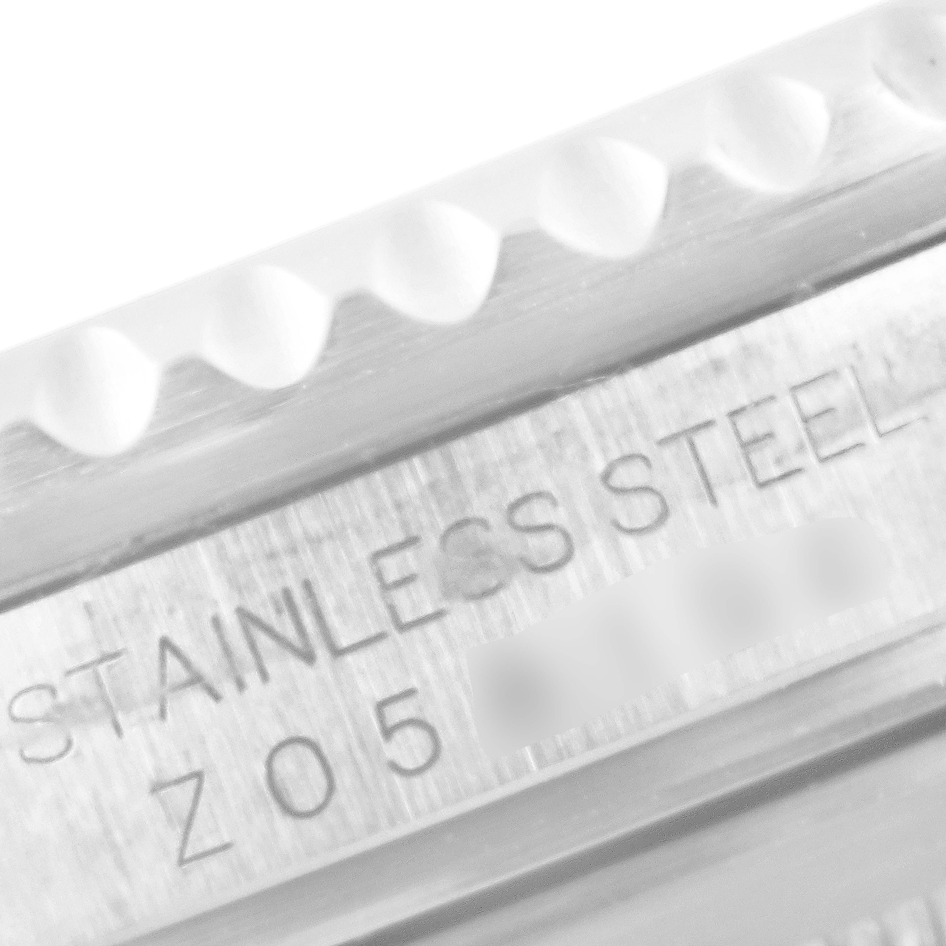 The image shows a close-up of the side of a Rolex Submariner 16610 Men
s Stainless Steel Black Dial 16610 Men
s Stainless Steel Black Dial watch case, focusing on the engraved "STAINLESS STEEL" text.