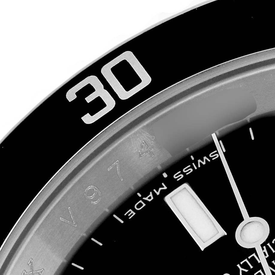 The image shows a close-up of the bezel and part of the dial of a Rolex Submariner 16610 Men
s Stainless Steel Black Dial 16610 Men
s Stainless Steel Black Dial watch, highlighting the "30" minute marker and Swiss Made text.