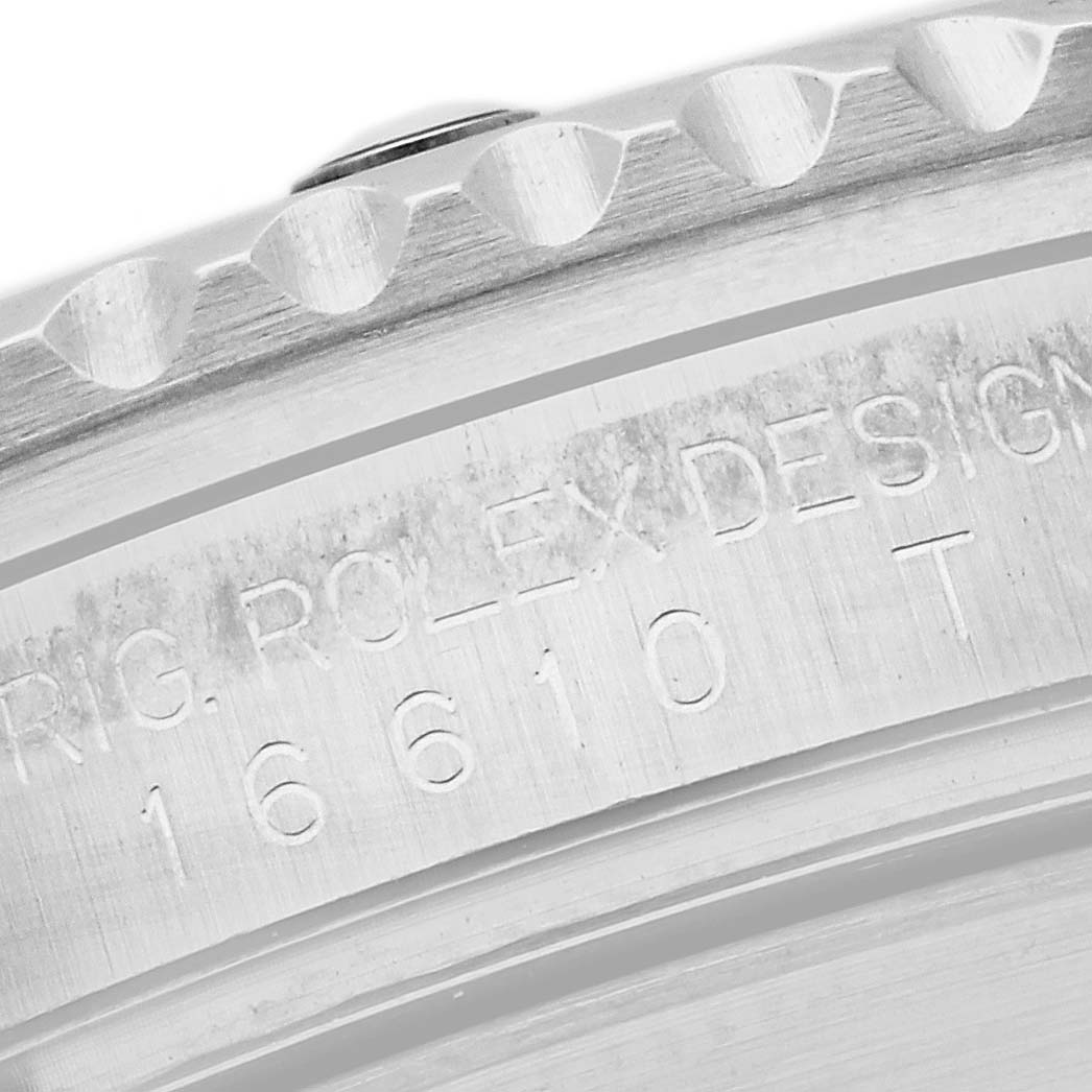 This image shows a close-up of the model number engraving and the bezel of a Rolex Submariner 16610 Men's Stainless Steel Black Dial 16610 Men's Stainless Steel Black Dial watch.