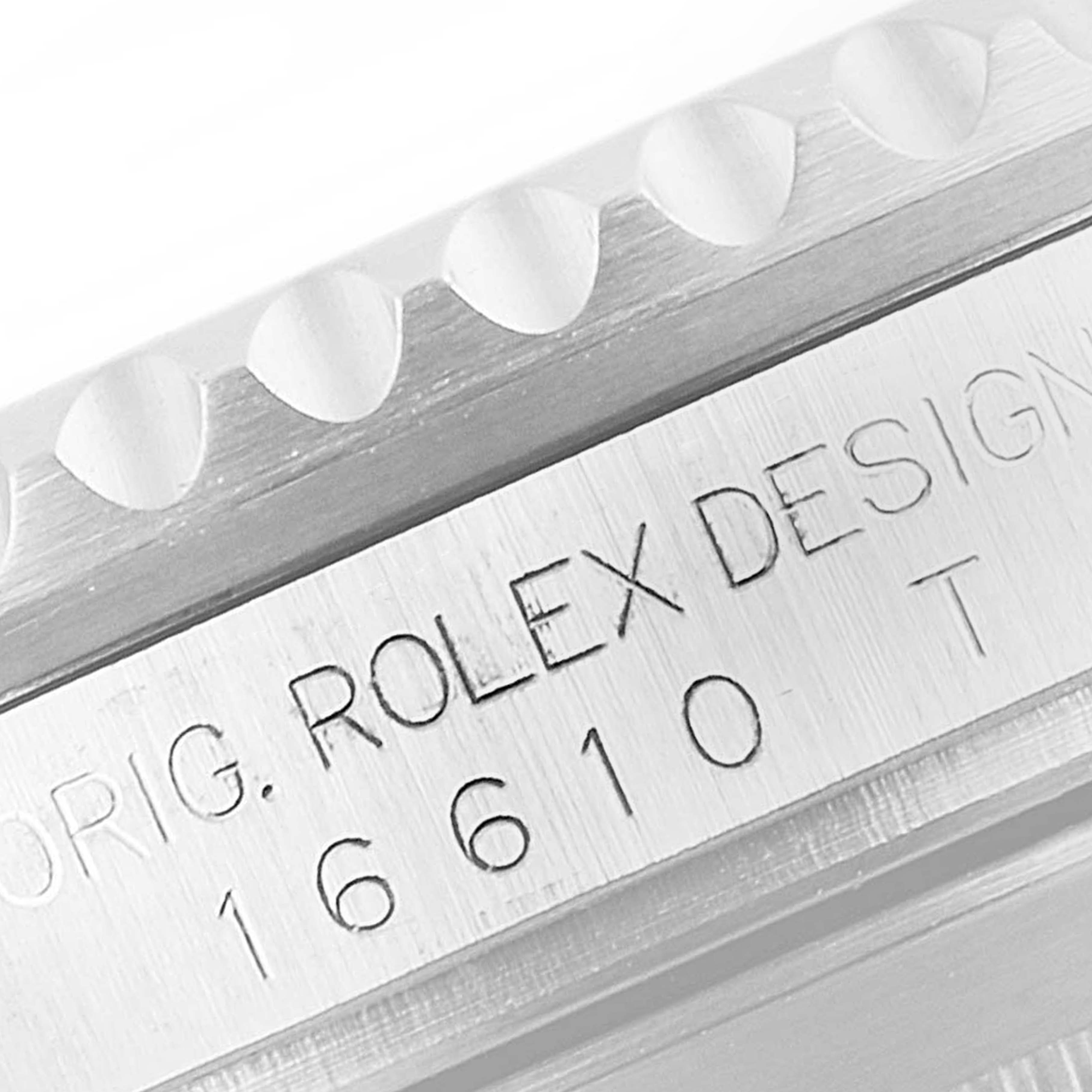 The image shows a close-up of the engraved side of the Rolex Submariner 16610LV Men
s Stainless Steel Black Dial 16610LV Men
s Stainless Steel Black Dial model 16610
s case.