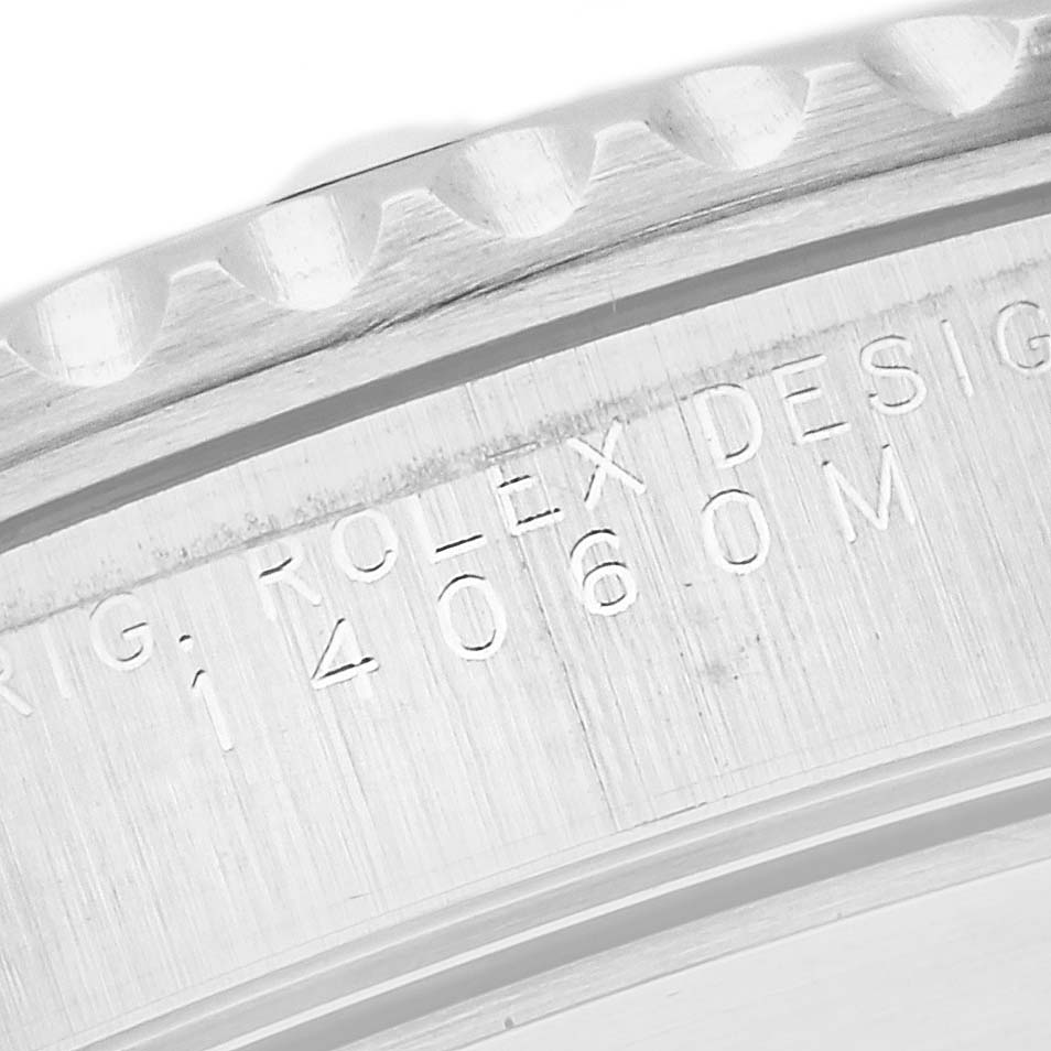 This image shows a close-up of the engraved inner bezel of a Rolex Submariner 14060 Men's Stainless Steel Black Dial 14060 Men's Stainless Steel Black Dial watch.