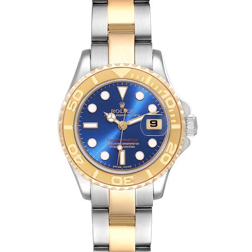 The Rolex Yacht-Master watch is shown from a top-down angle, displaying its blue dial, gold bezel, and two-tone bracelet.