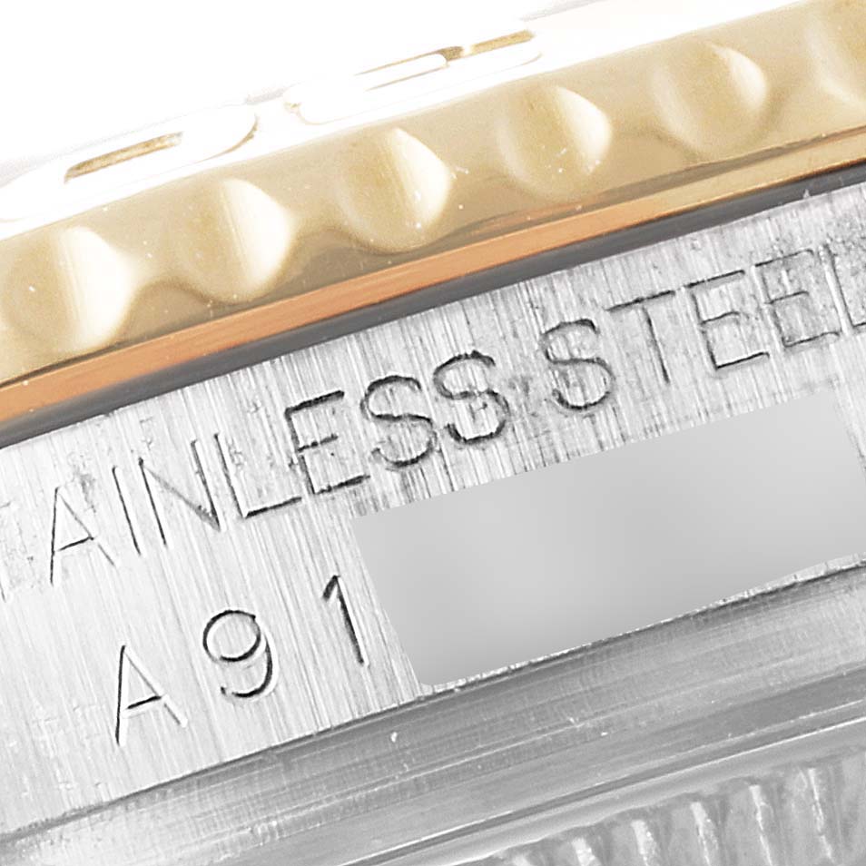 The image shows a close-up of the side of the bezel and case of a Rolex Yacht-Master 168623 Men
s Steel and Gold (two tone) White Dial 168623 Men
s Steel and Gold (two tone) White Dial watch, highlighting the "STAINLESS STEEL" engraving.