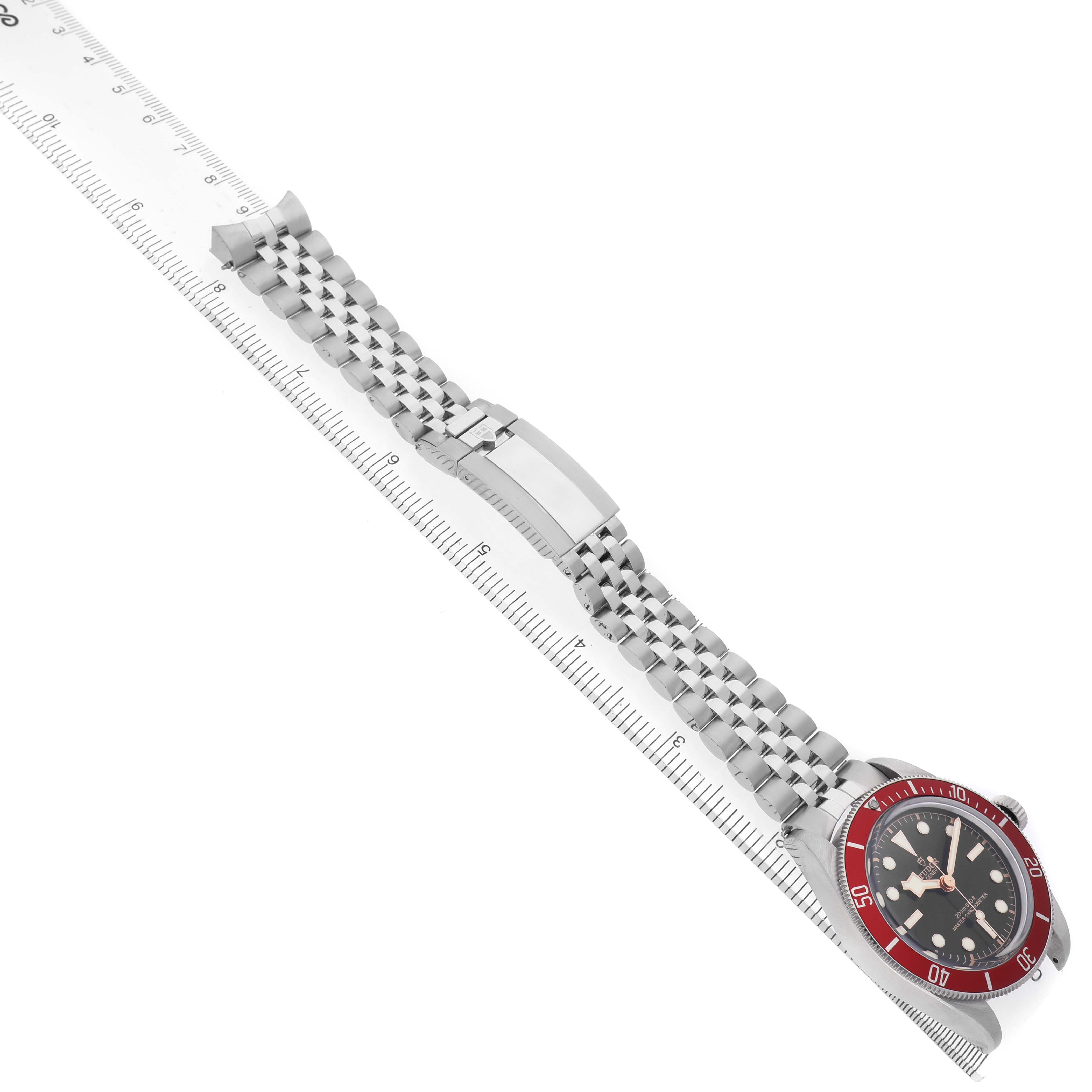 The image shows a Tudor Heritage Black Bay 7941A1A0 Mens Stainless Steel Black Dial watch at an angle, featuring the face, bezel, bracelet, and clasp.