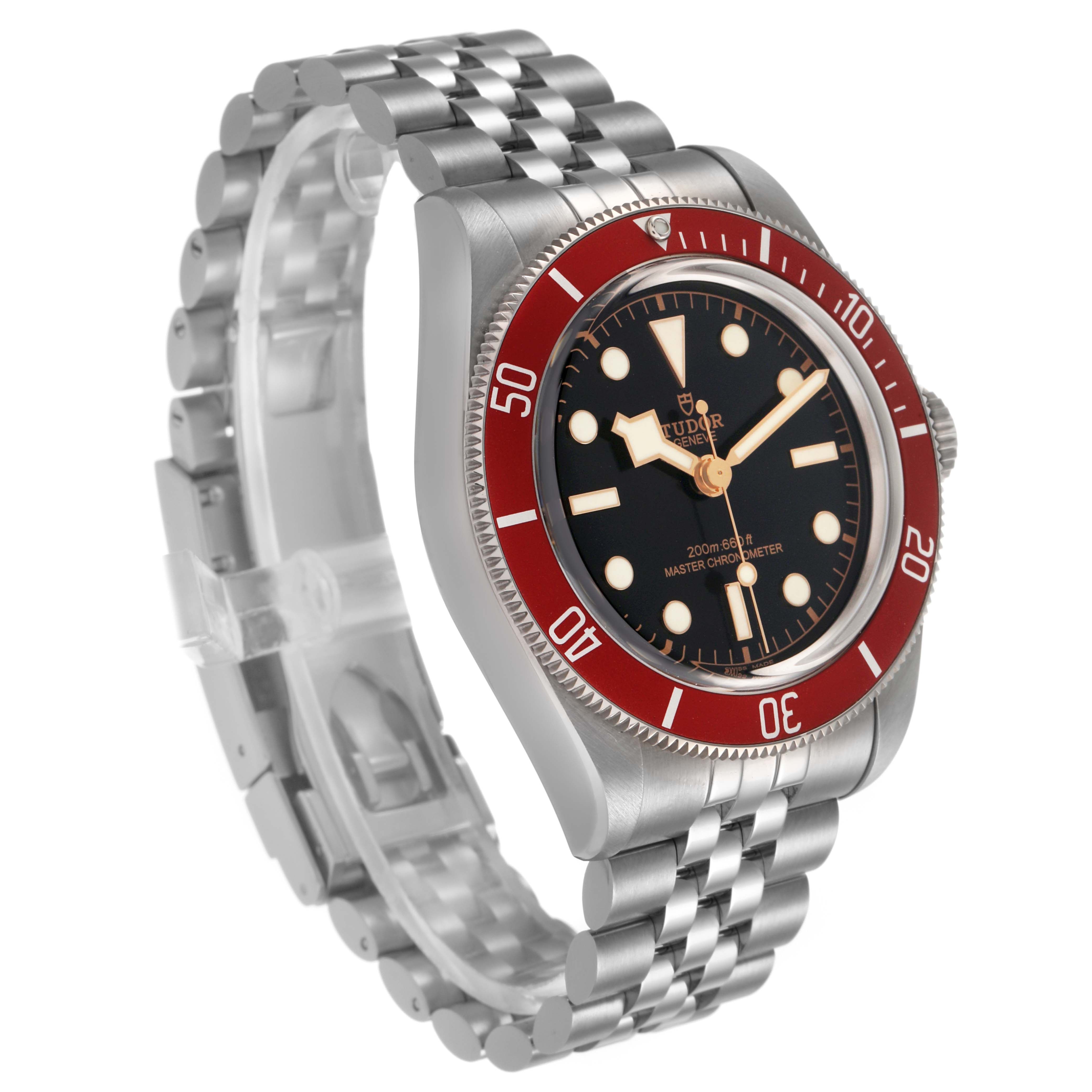 The Tudor Heritage Black Bay 7941A1A0 Mens Stainless Steel Black Dial watch is shown at a three-quarter angle, highlighting the red bezel, black dial, and silver bracelet.