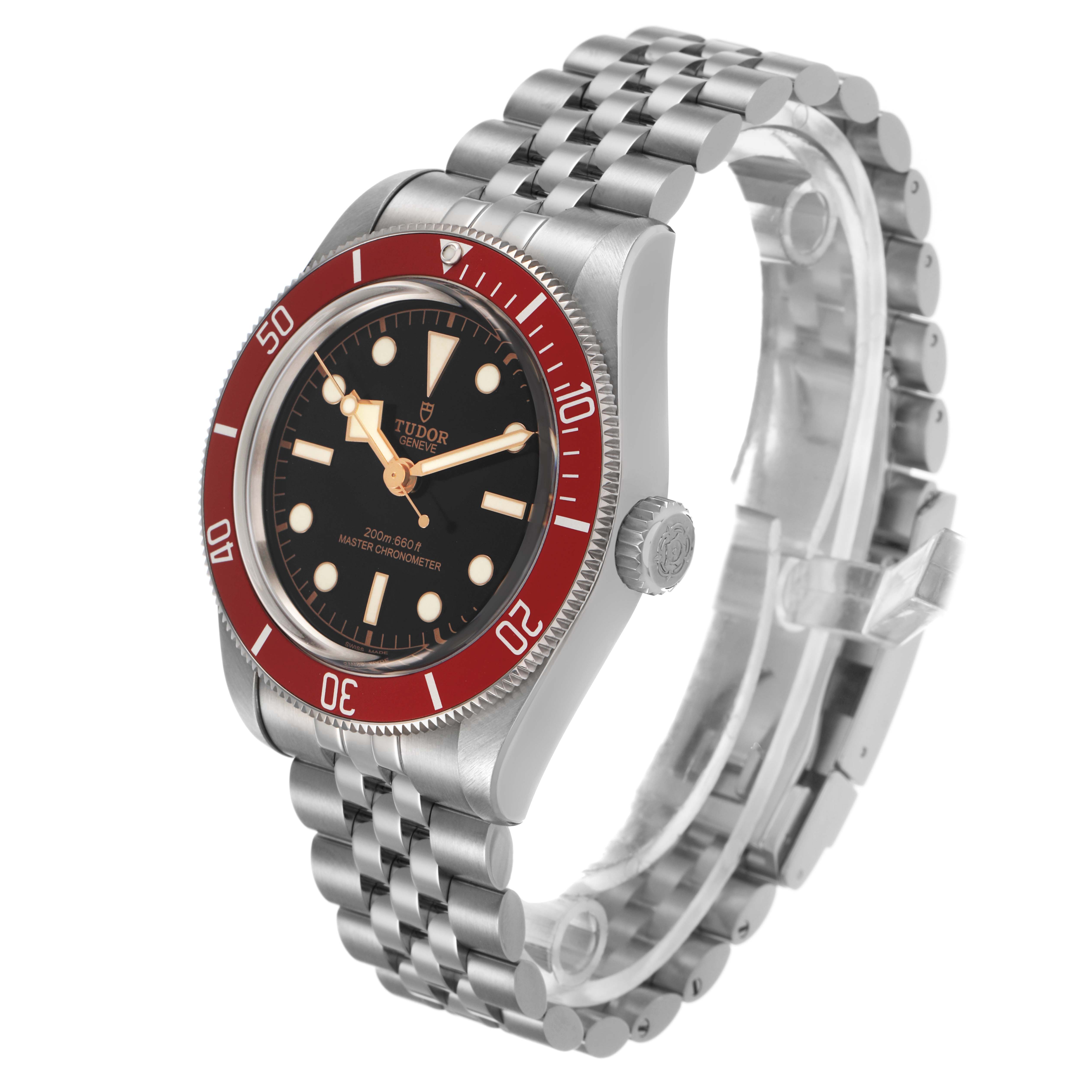 The Tudor Heritage Black Bay 7941A1A0 Men's Stainless Steel Black Dial watch is shown at a three-quarter angle, highlighting the red bezel, black dial, and jubilee bracelet.
