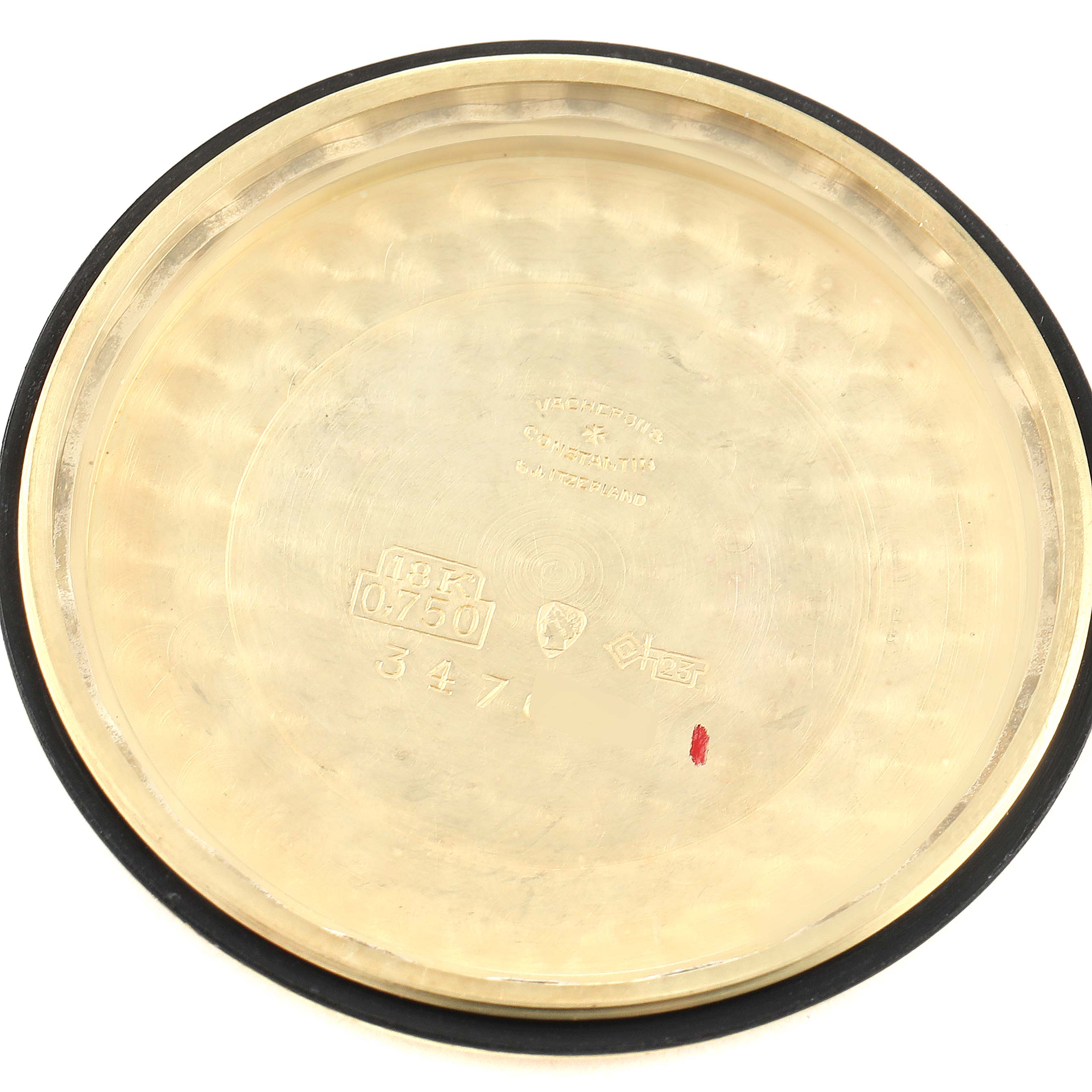 This image shows the inside case back of a Vintage Vacheron Constantin watch, revealing hallmark and serial numbers.