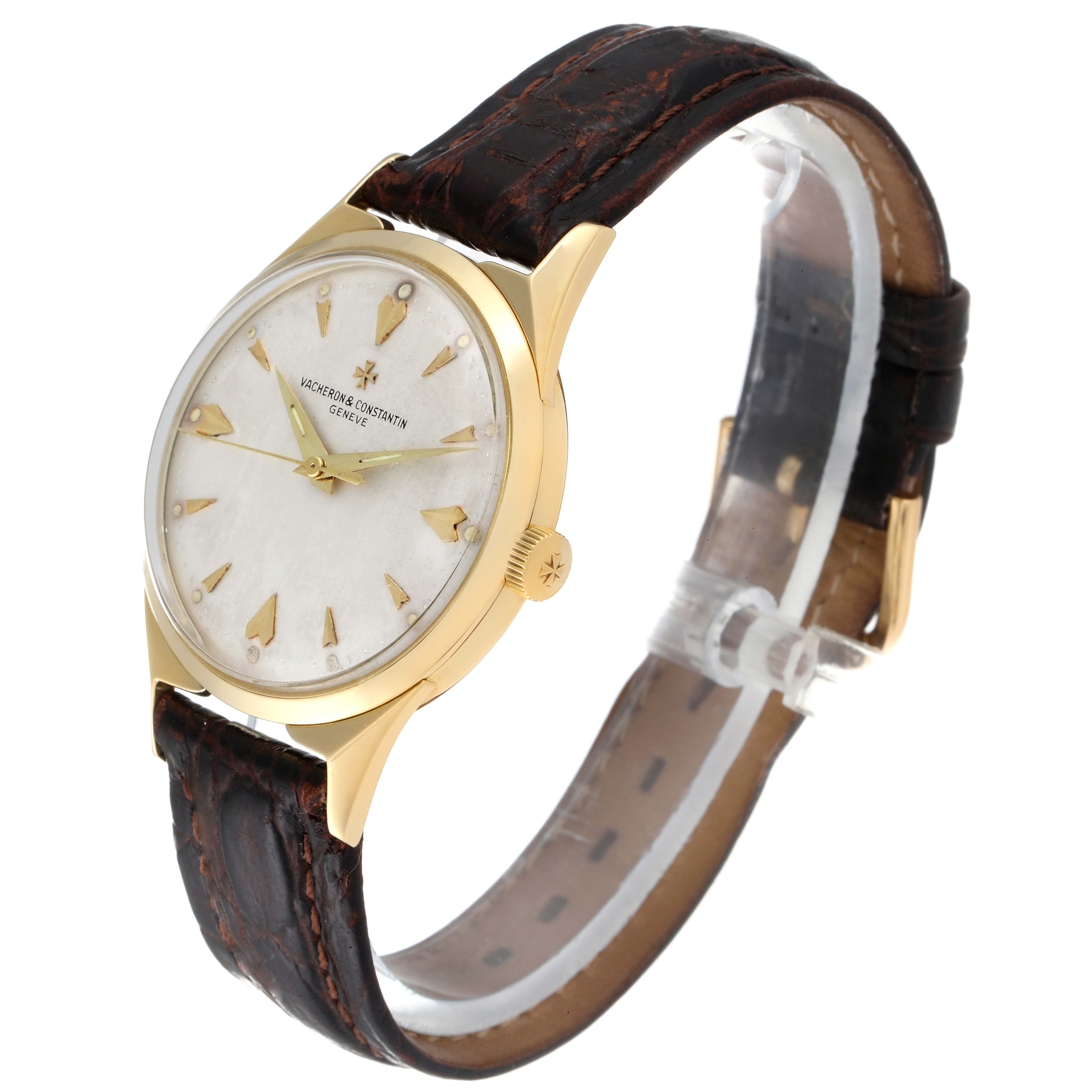 This image shows a side angle of a Vintage Vacheron Constantin watch, highlighting its gold case, white dial, and brown leather strap.
