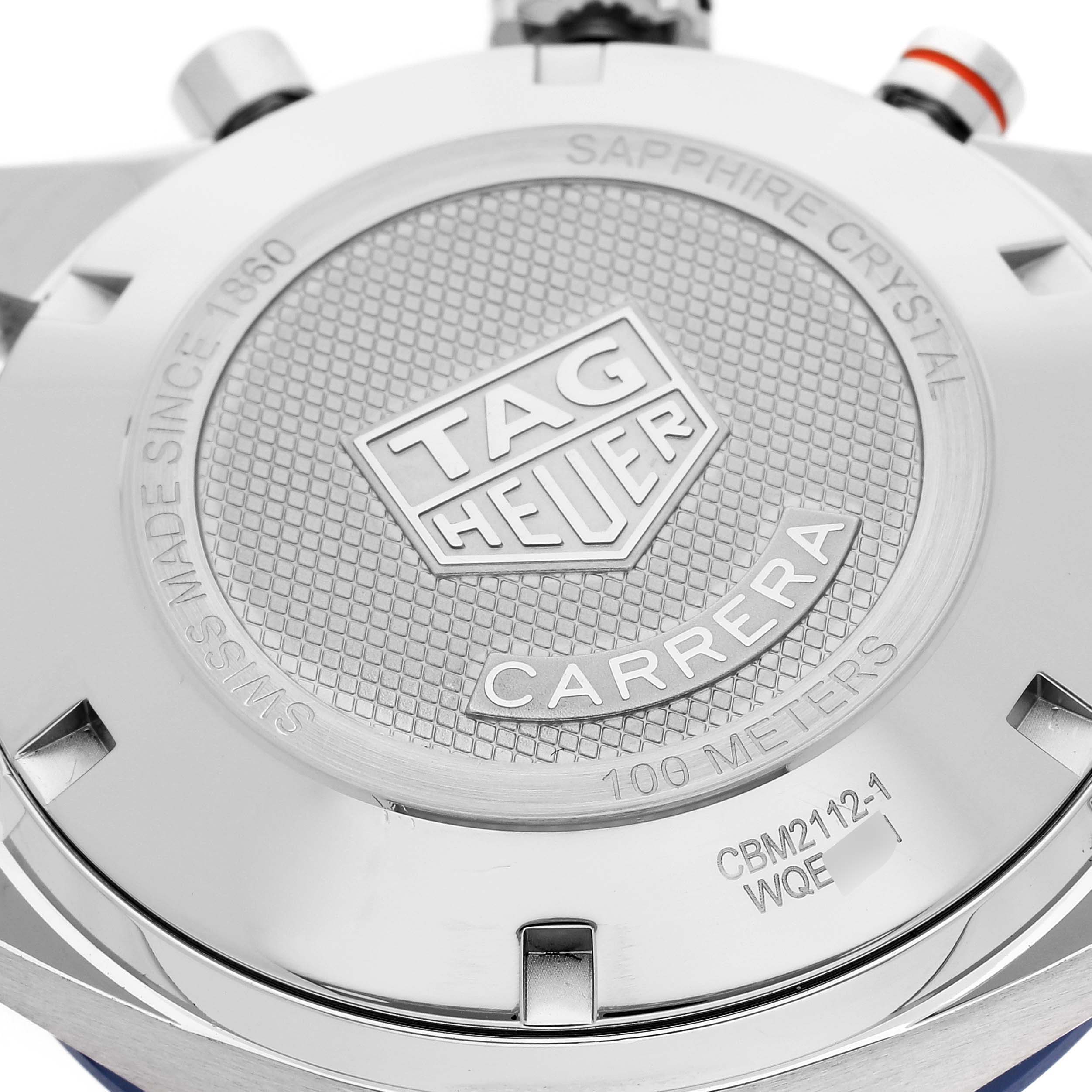 The image shows the back case of a Tag Heuer Carrera CBM2112 Men's Stainless Steel Blue Dial CBM2112 Men's Stainless Steel Blue Dial watch, highlighting the brand logo and model details.