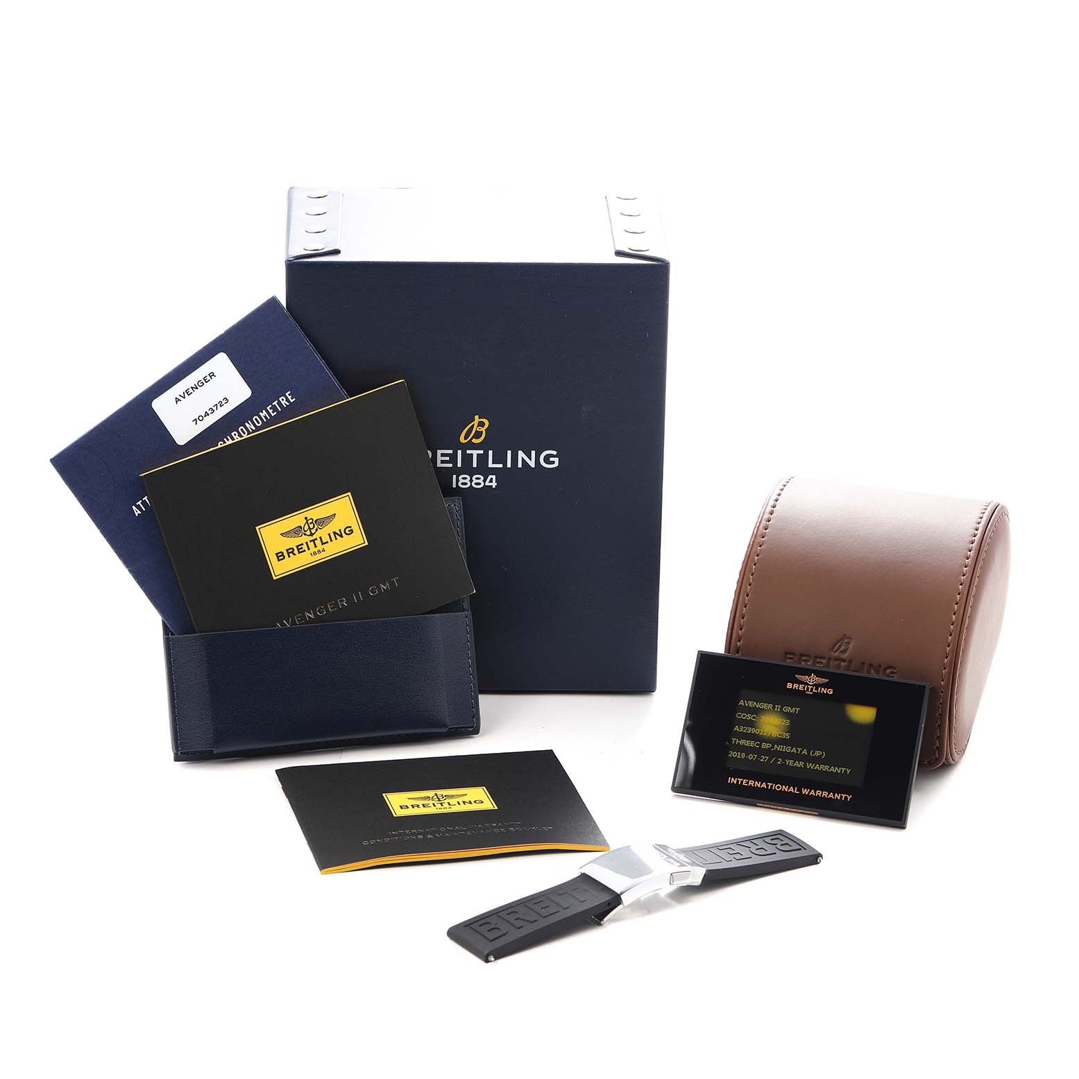 The image shows the Breitling Avenger A3239011/BC35 Men
s Stainless Steel Black Dial watch packaging, including a box, warranty cards, and a strap laid out at an angle.