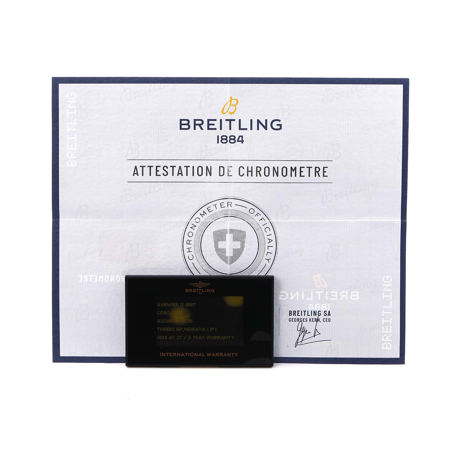 The image shows the Breitling Avenger A3239011/BC35 Men
s Stainless Steel Black Dial model
s documentation and warranty card from a front angle.