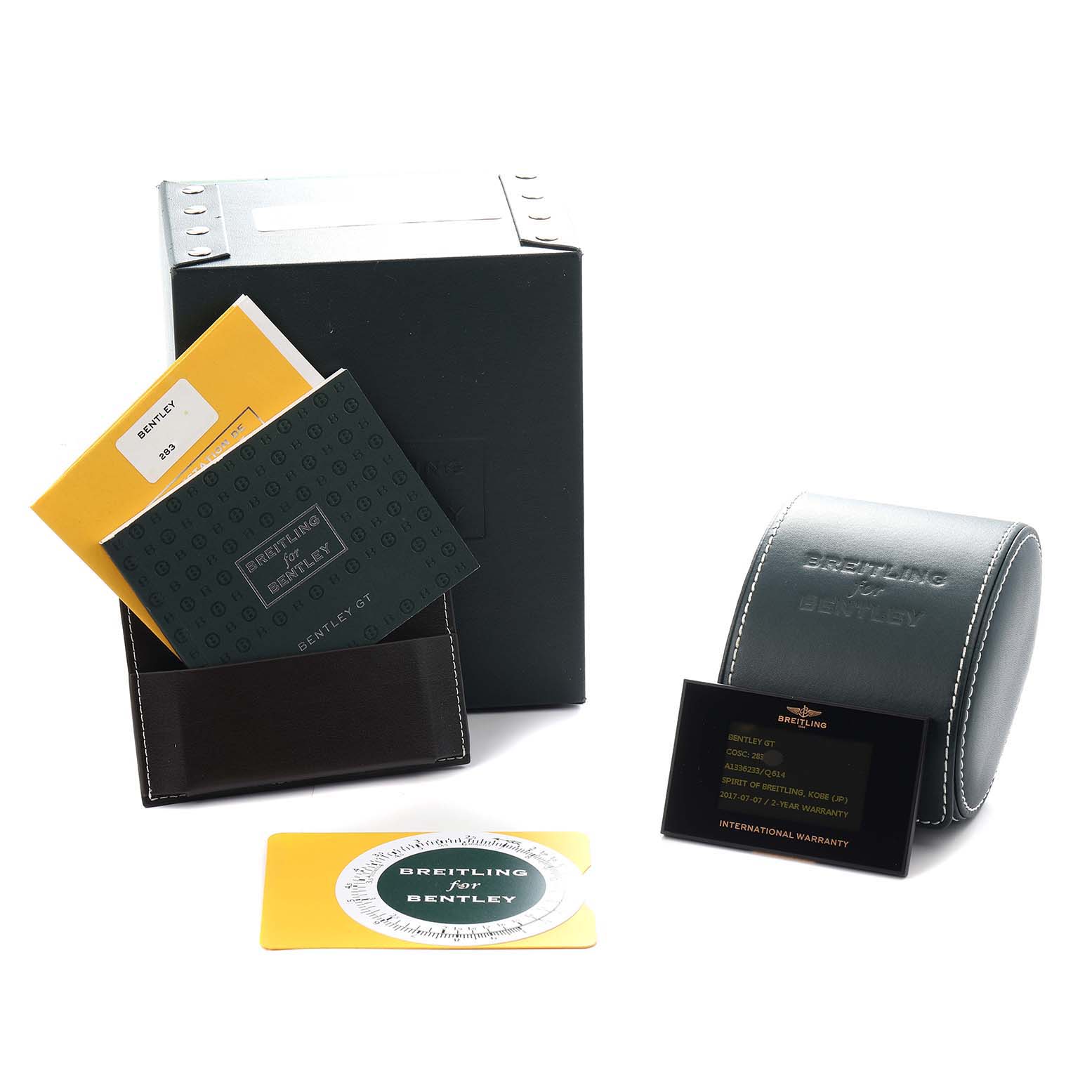 The image shows the Breitling for Bentley watch accessories, including a box, manuals, warranty card, and a case, angled slightly from above.